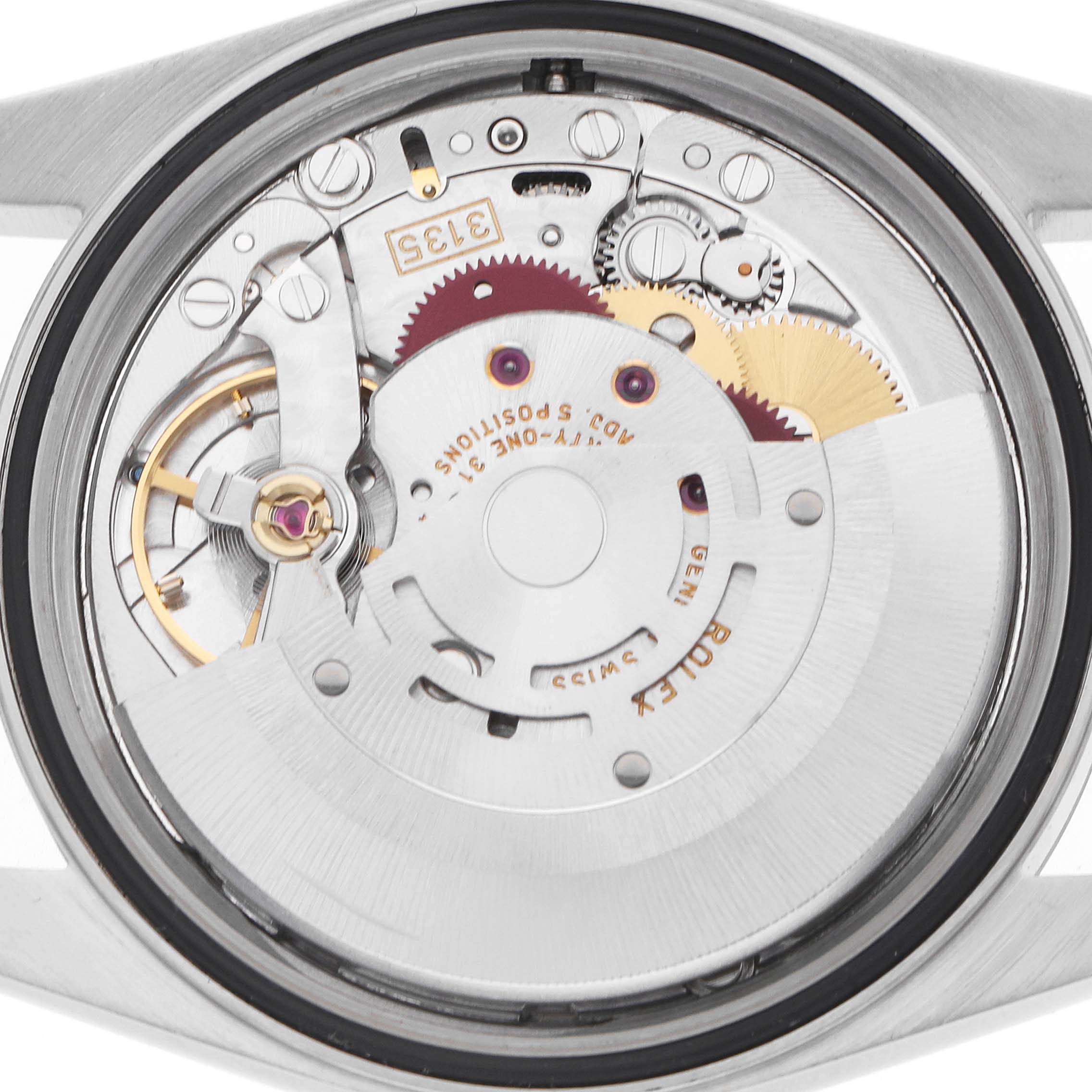 The image shows the inner mechanism of a Rolex Datejust 16234 Men
s Stainless Steel Silver Dial, viewed from the back, highlighting gears and movement components.