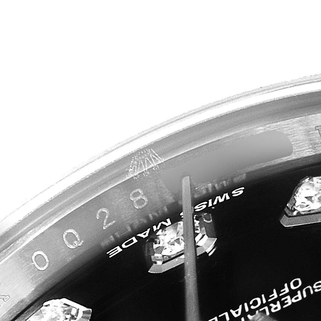 This close-up image of a Rolex Datejust 179174  Women's Stainless Steel Black Dial 179174  Women's Stainless Steel Black Dial watch shows the dial, crystal, and diamond markers at an oblique angle.