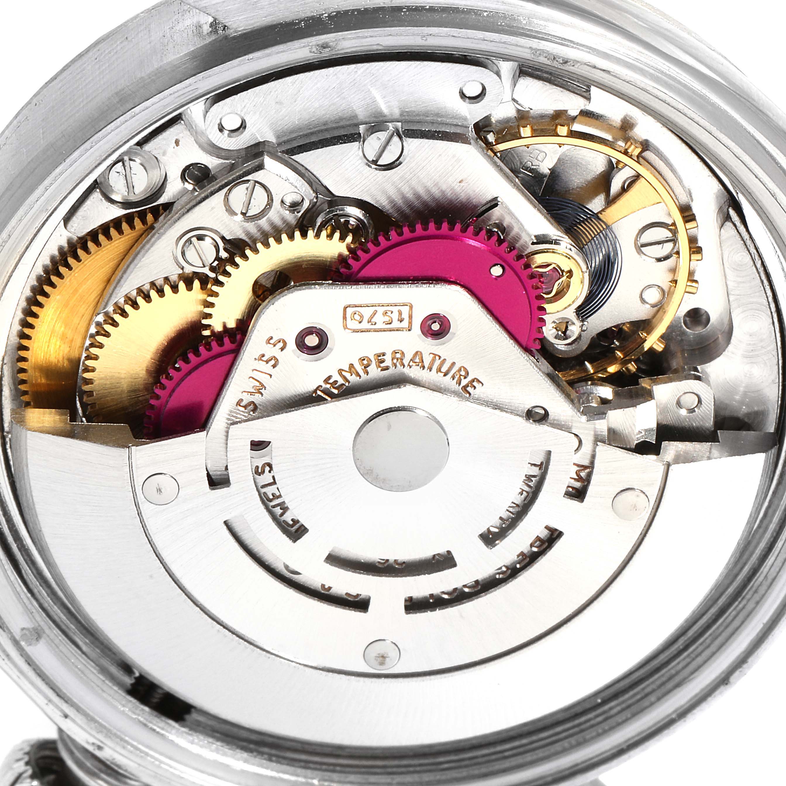 The image shows a close-up view of the internal mechanical movement of a Vintage Collection Rolex watch, highlighting gears and components.