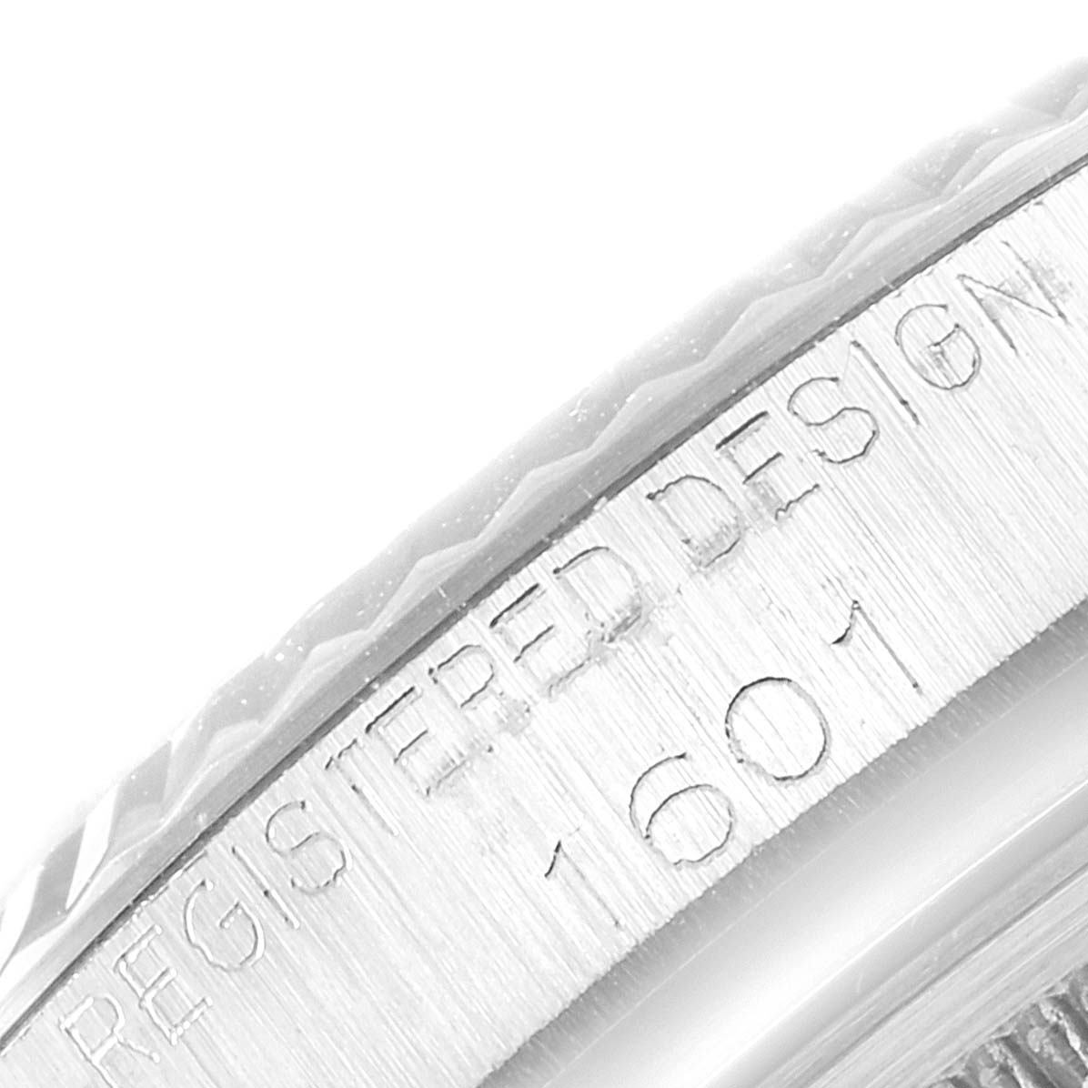 The image shows a close-up of the bezel and case edge of the Vintage Collection model 1601 by Rolex.