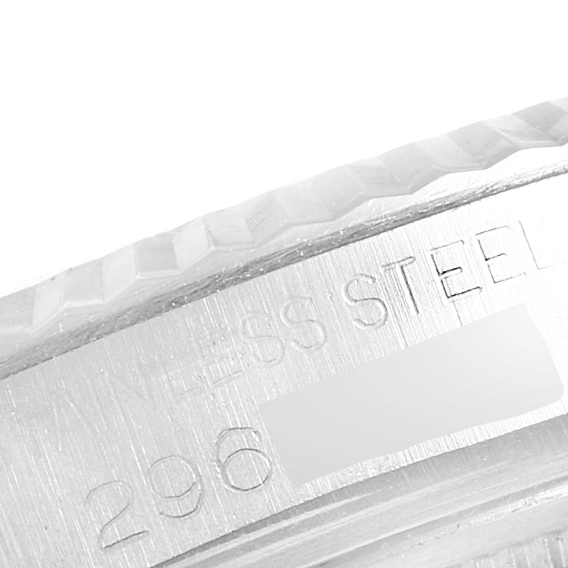 This image shows a close-up of the case side engraving and part of the bezel of a Rolex Vintage Collection 1601 Men's Stainless Steel Grey Dial 1601 Men's Stainless Steel Grey Dial watch.