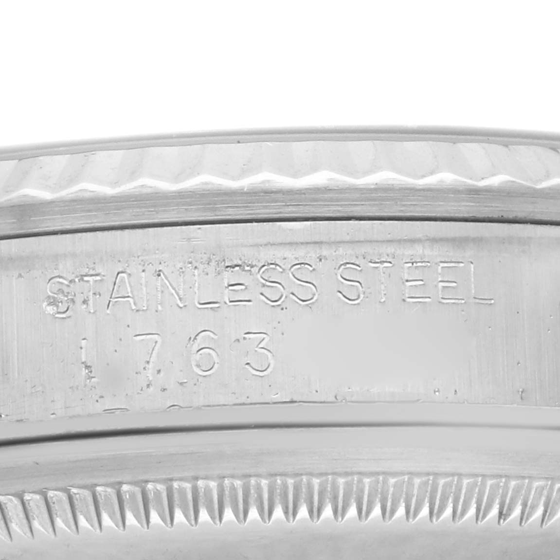 This image shows a close-up angle of the engraved case back of the Rolex Datejust 16234 Men's Stainless Steel Silver Dial 16234 Men's Stainless Steel Silver Dial watch, highlighting the text "STAINLESS STEEL" and the number "1763".