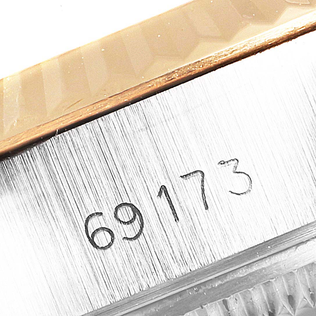 Close-up of the Rolex Datejust 69173 Women
s Steel and Gold (two tone) Champagne Dial 69173 Women
s Steel and Gold (two tone) Champagne Dial model 69173, showing the serial number engraved on the side of the case.
