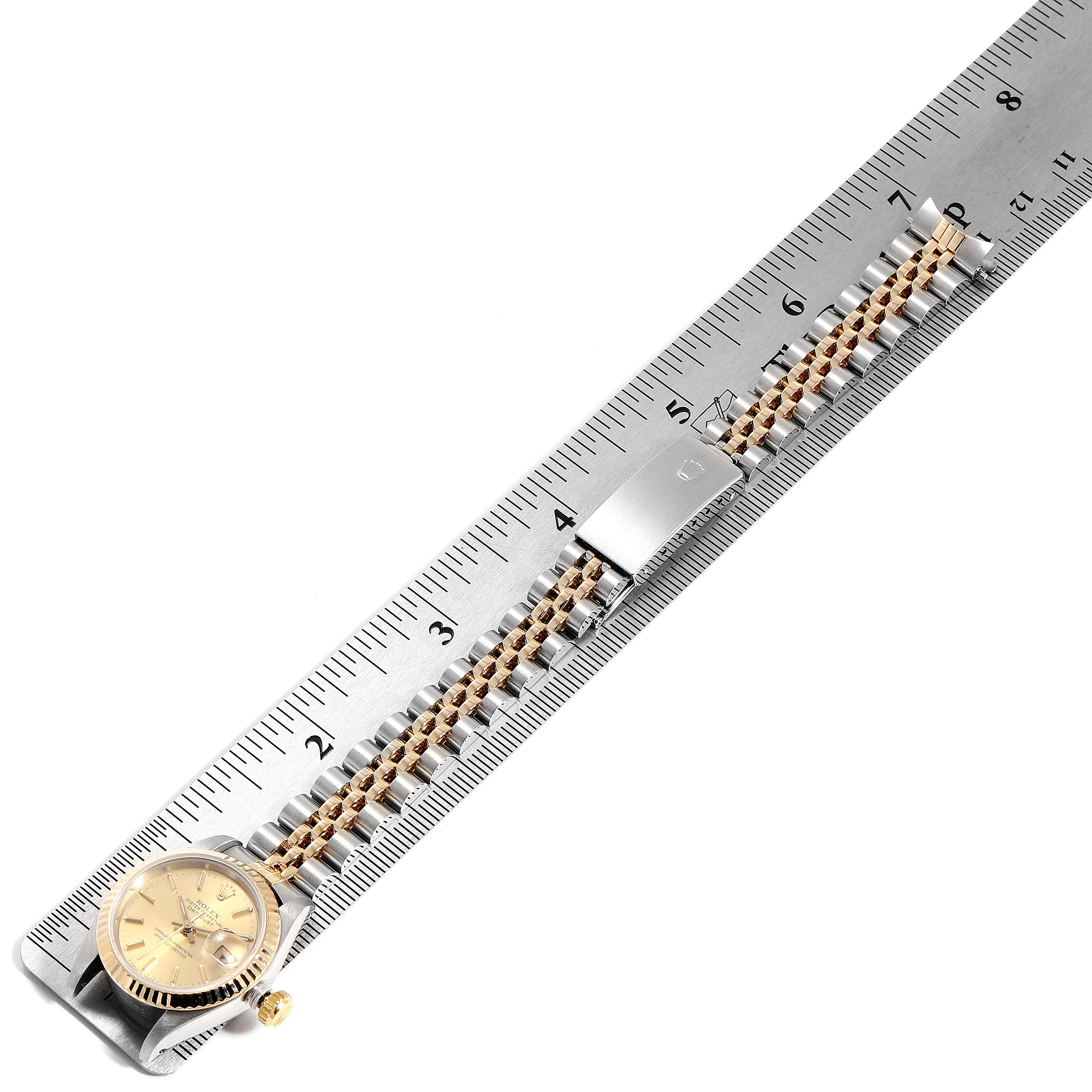 The image shows a Rolex Datejust 69173 Women
s Steel and Gold (two tone) Champagne Dial 69173 Women
s Steel and Gold (two tone) Champagne Dial watch lying flat with its strap stretched along a ruler for measurement.