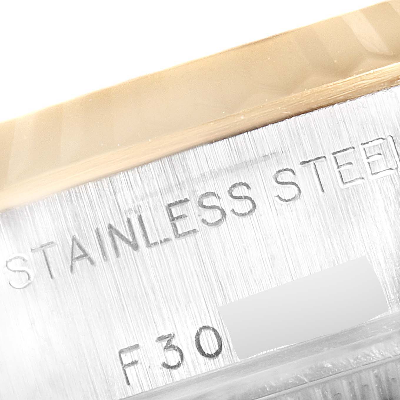 The image shows a close-up view of the engraving on the stainless steel case of a Rolex Datejust 79173 Women
s Steel and Gold (two tone) Silver Dial 79173 Women
s Steel and Gold (two tone) Silver Dial watch.