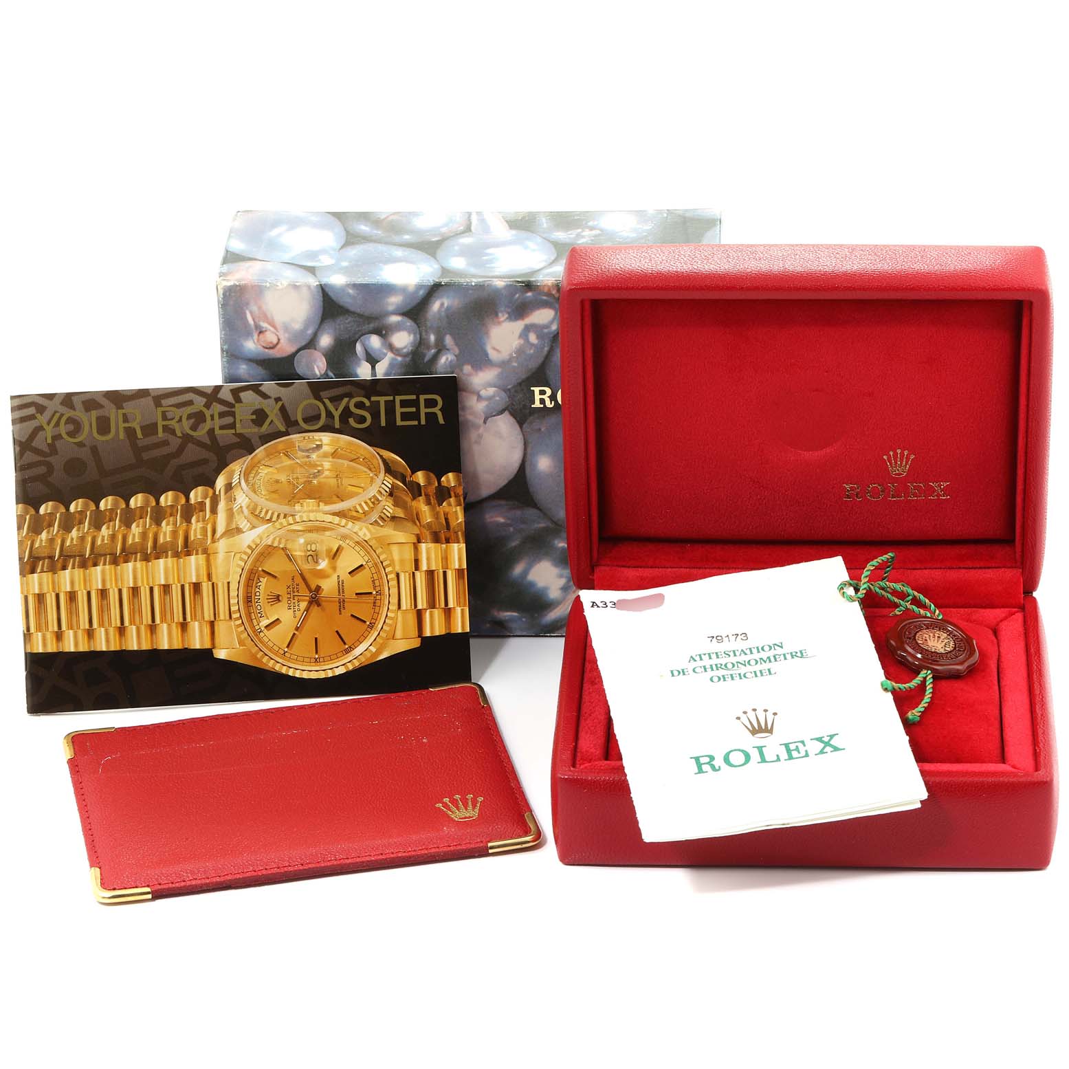 This is a Rolex Datejust 79173 Women's Steel and Gold (two tone) Champagne Dial 79173 Women's Steel and Gold (two tone) Champagne Dial watch box set, including a red case, paperwork, and tags, shown from an angled top view.