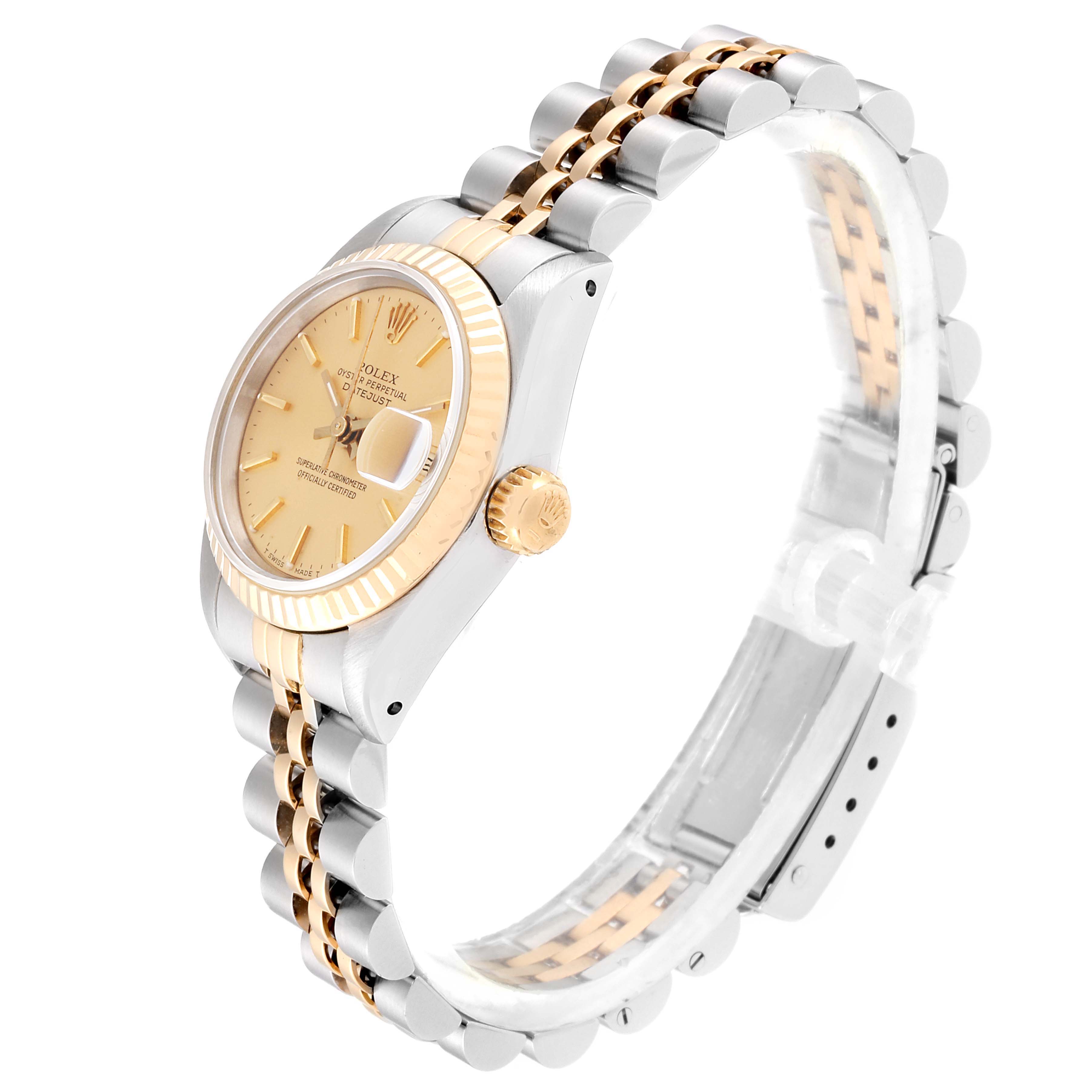 The image shows a side angle of a Rolex Datejust 69173 Women
s Steel and Gold (two tone) Champagne Dial 69173 Women
s Steel and Gold (two tone) Champagne Dial watch, displaying its dial, crown, and the two-tone metal bracelet.