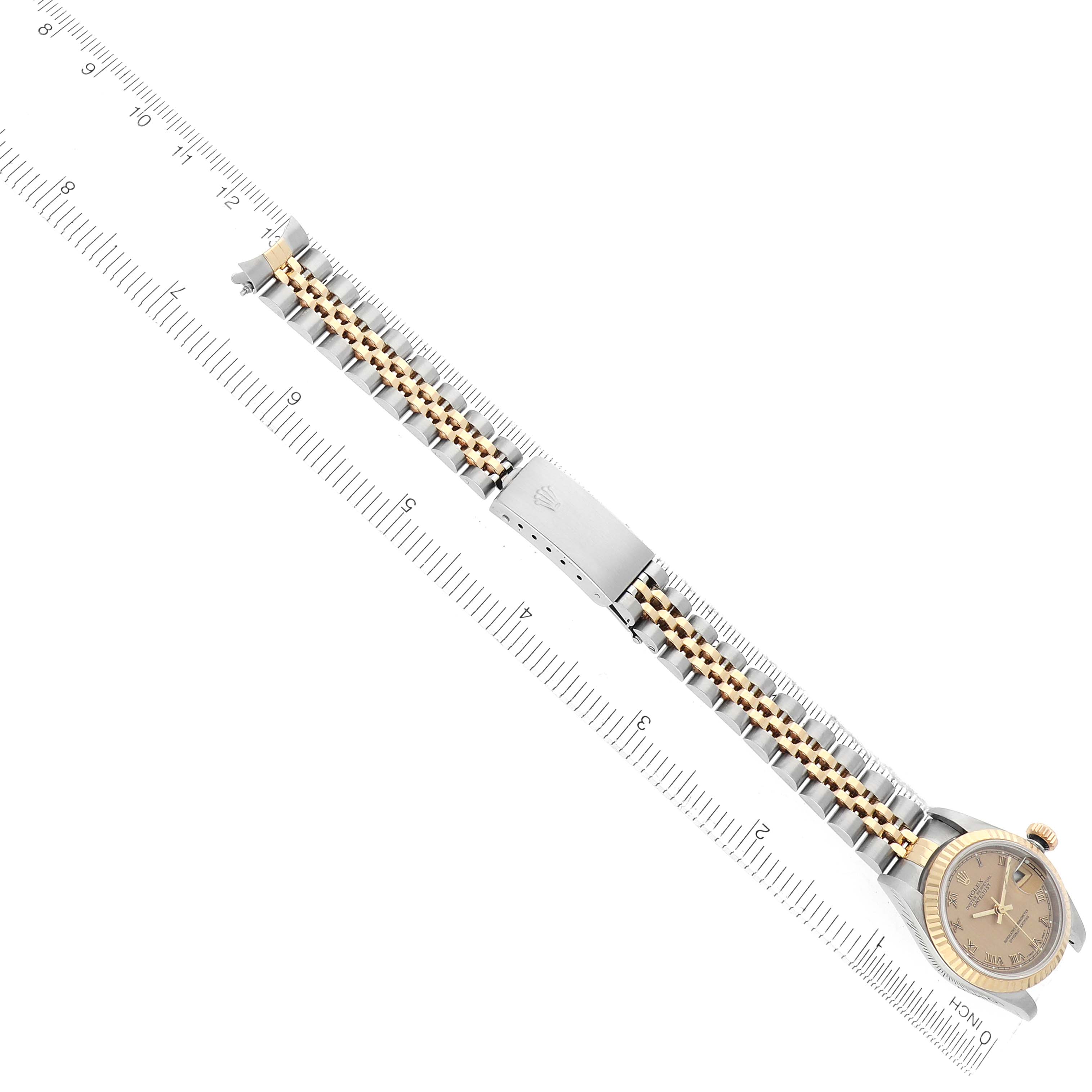 The image shows a Rolex Datejust 79173 Women
s Steel and Gold (two tone) Champagne Dial watch from a top-down angle, highlighting the face, bracelet, and clasp.