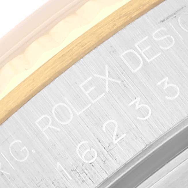 The image shows a close-up of the side of a Rolex Datejust 16233 Men's Steel and Gold (two tone) White Dial 16233 Men's Steel and Gold (two tone) White Dial watch, focusing on the engraved model information.
