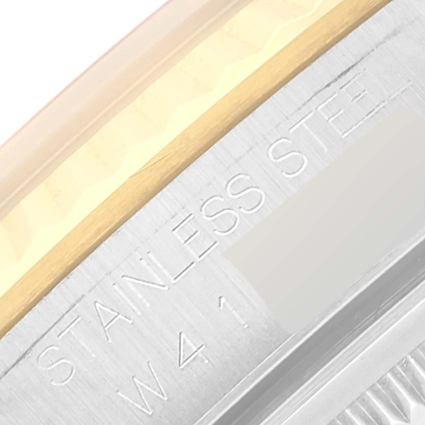 The image displays a close-up of the case side of a Rolex Datejust 16233 Men's Steel and Gold (two tone) White Dial 16233 Men's Steel and Gold (two tone) White Dial watch, highlighting the "STAINLESS STEEL" engraving.