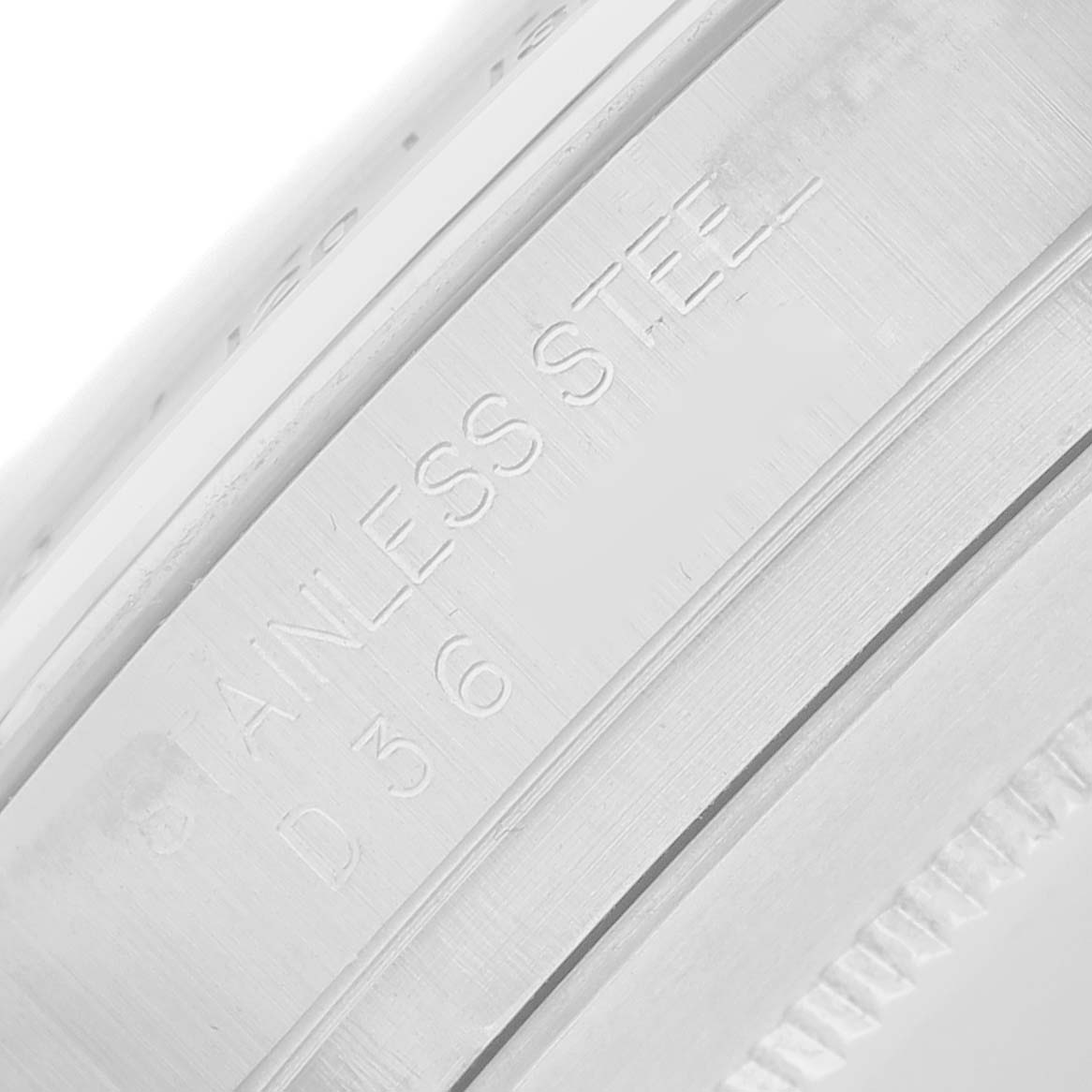 The image shows a close-up angle of the casing material featuring engraved text on the Rolex Daytona 116520 Men
s Stainless Steel White Dial.