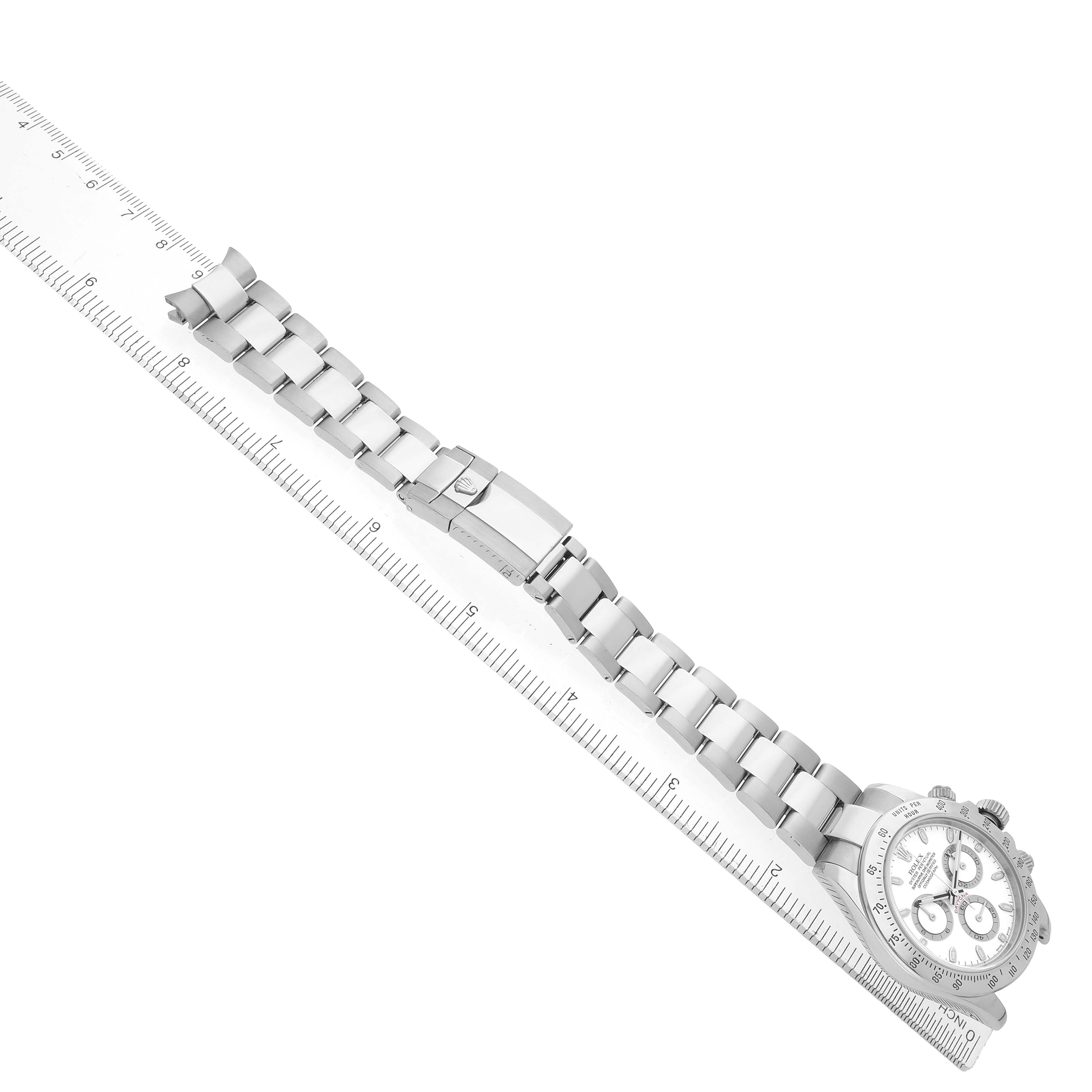 The image shows a silver Rolex Daytona 116520 Men
s Stainless Steel White Dial watch at an angle, displaying the full bracelet and clasp alongside a ruler.