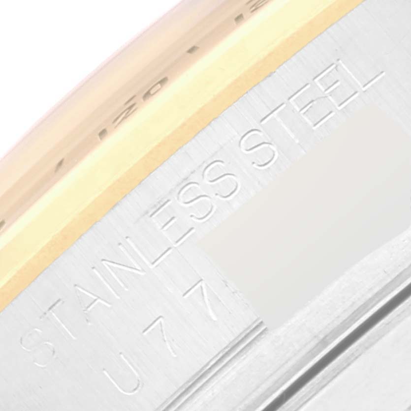 The image shows a close-up of the engraved "STAINLESS STEEL" and partial serial number on the case back of a Rolex Daytona 16523 Men
s Steel and Gold (two tone) Black Dial 16523 Men
s Steel and Gold (two tone) Black Dial watch.