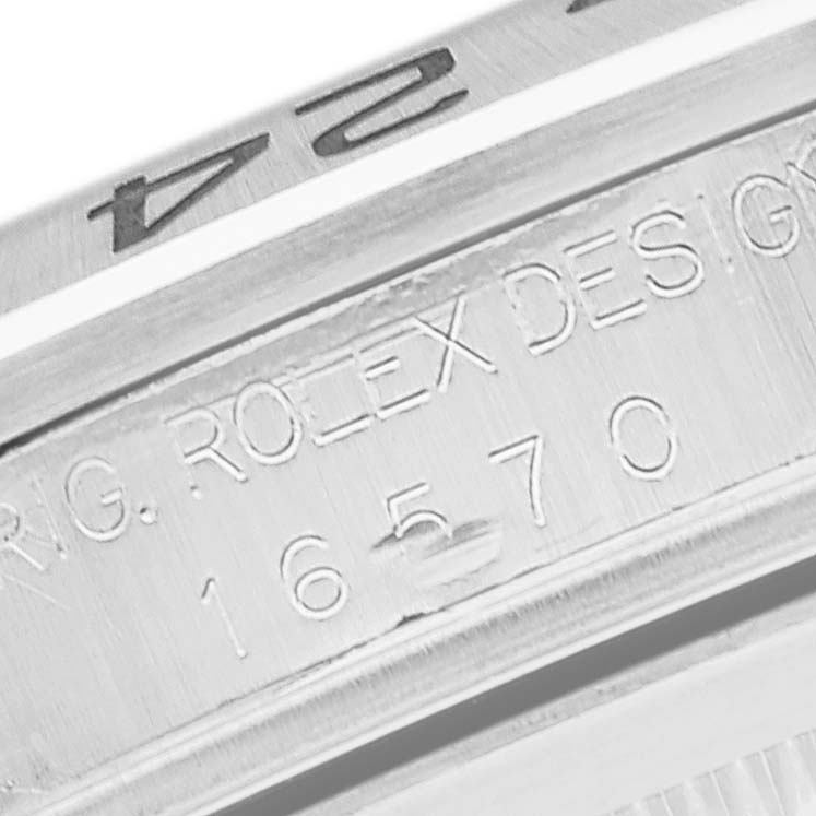 The image shows a close-up of the engraving on the side of the bezel and case of a Rolex Explorer 16570 Men
s Stainless Steel White Dial 16570 Men
s Stainless Steel White Dial model.