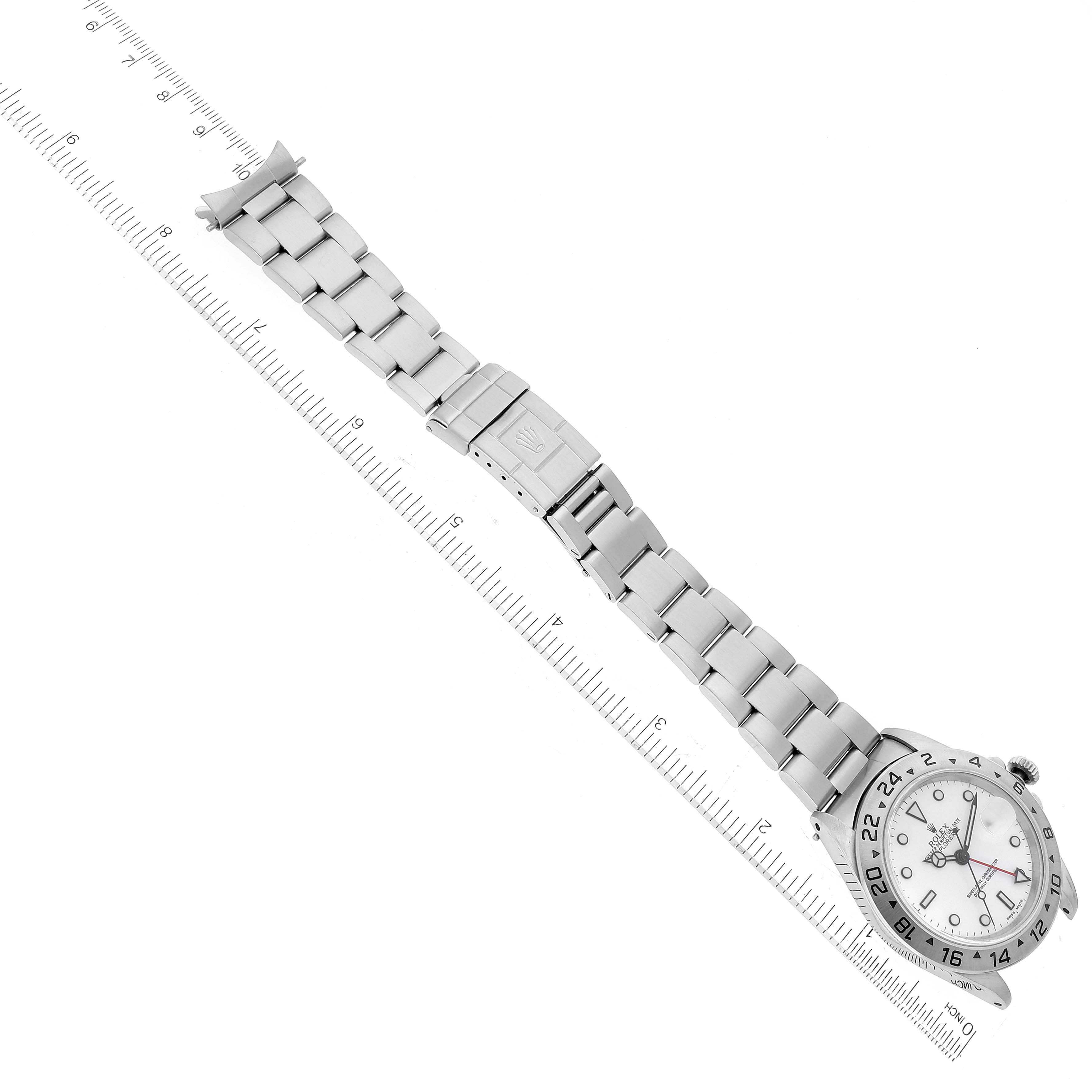 The image shows a Rolex Explorer 16570 Men
s Stainless Steel White Dial 16570 Men
s Stainless Steel White Dial watch lying flat from a top-down angle near a ruler for size reference.