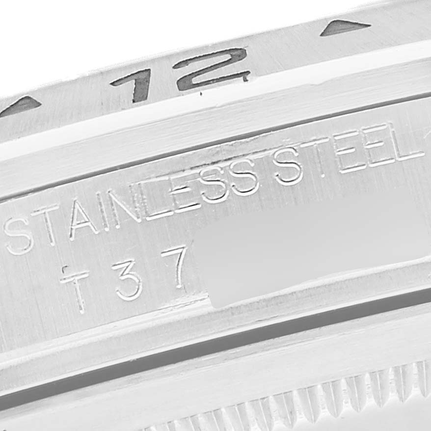 The image shows a close-up of the stainless steel case and engraved bezel of a Rolex Explorer 16570 Men
s Stainless Steel White Dial 16570 Men
s Stainless Steel White Dial watch.