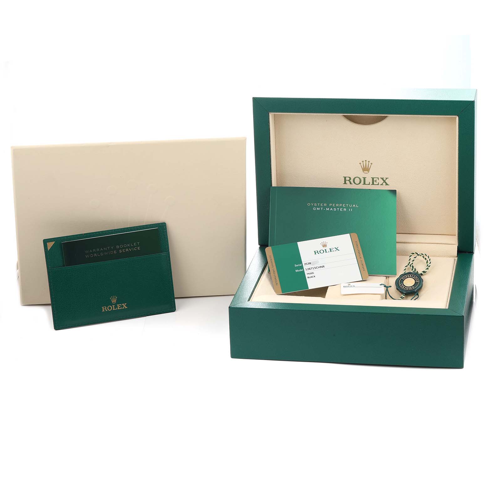 The image shows a Rolex GMT-Master 126715 Men
s Rose Gold Black Dial watch box with warranty cards, a booklet, and a tag.