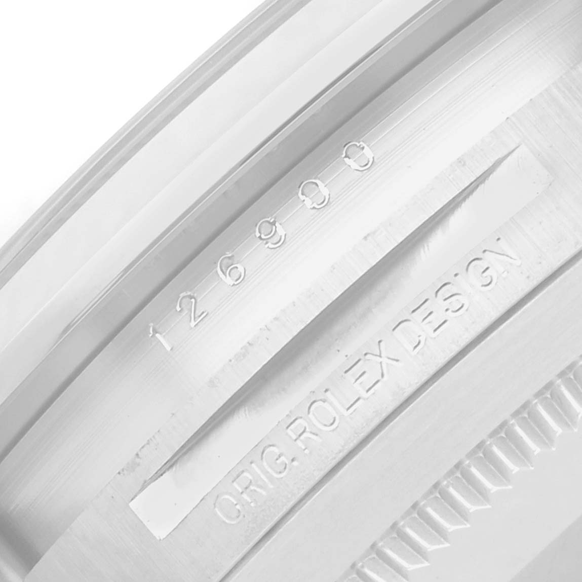 The image shows the engraved inner bezel of a Rolex Air-King 126900 Men
s Stainless Steel Black Dial, highlighting its serial number and design inscription.