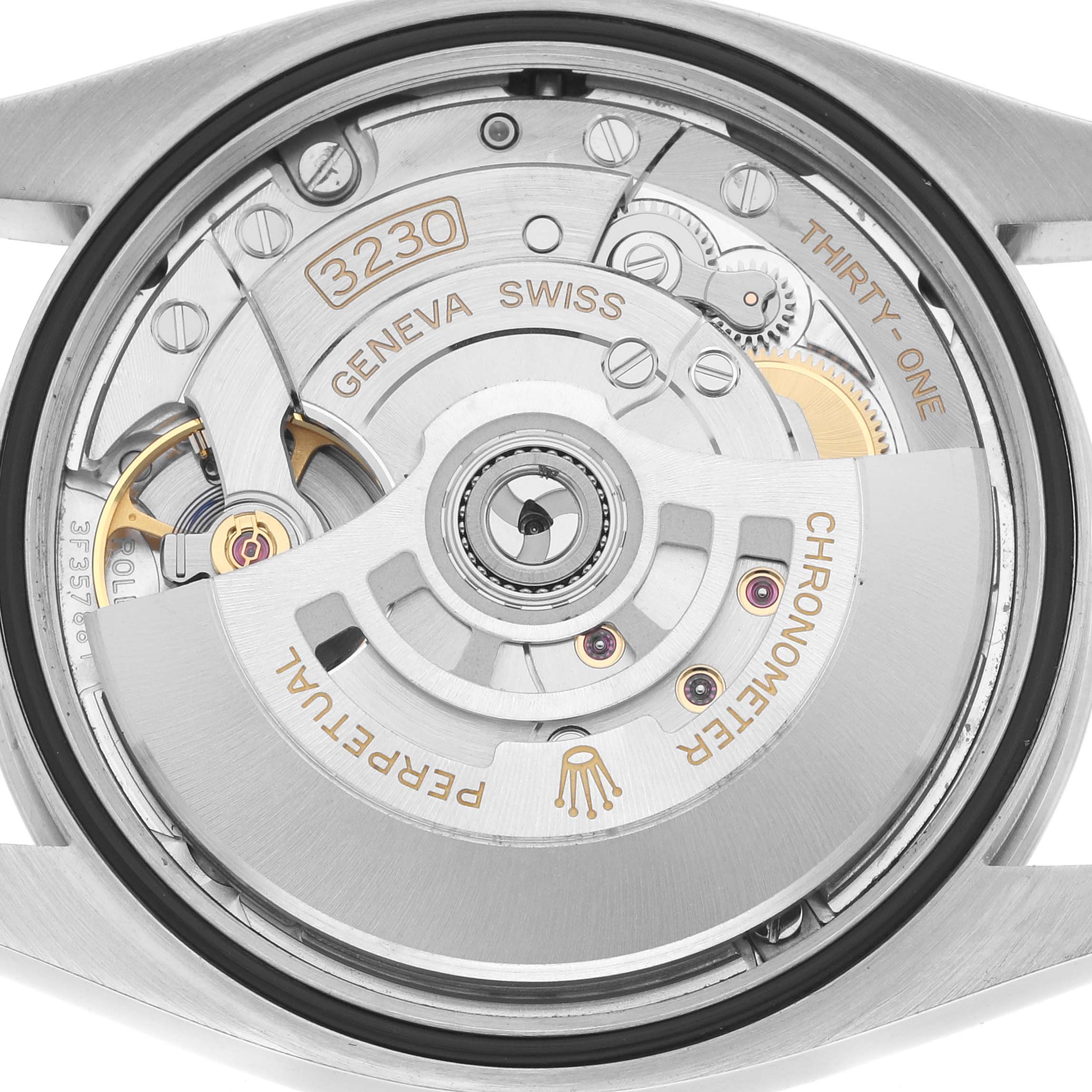 The image shows the back view of a Rolex Oyster Perpetual 126000 Men
s Stainless Steel Green Dial, highlighting the intricate movement and rotor.