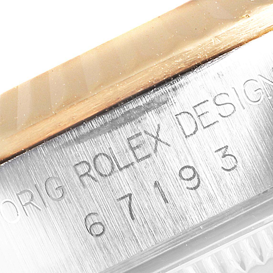 This image shows a close-up of the bezel and side engraving of a Rolex Oyster Perpetual 67193 Women's Steel and Gold (two tone) Grey Dial 67193 Women's Steel and Gold (two tone) Grey Dial watch.
