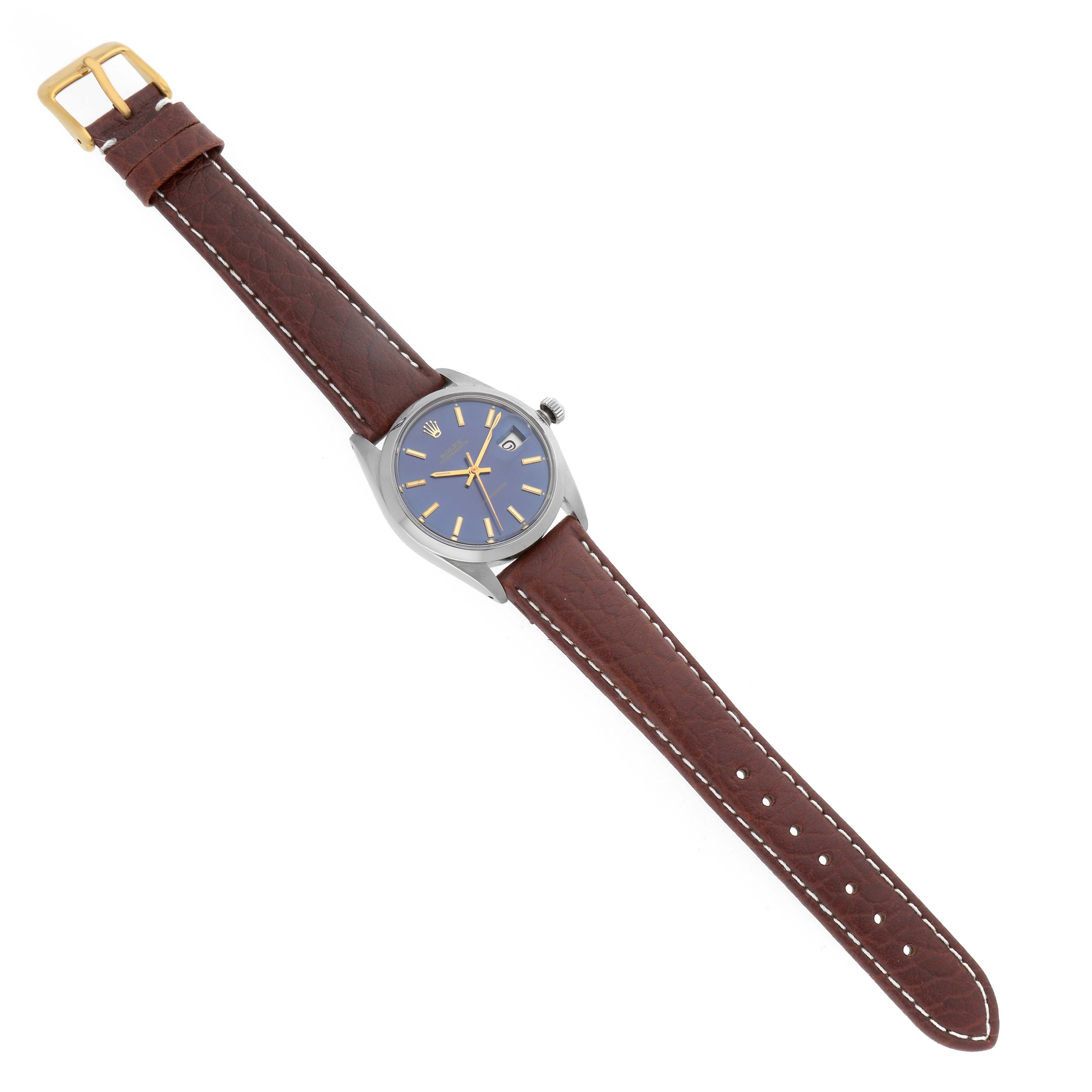 The Rolex Vintage Collection 6694 Men's Stainless Steel Blue Dial 6694 Men's Stainless Steel Blue Dial watch is shown from a top-down angle, displaying its blue dial, brown leather strap, and buckle.