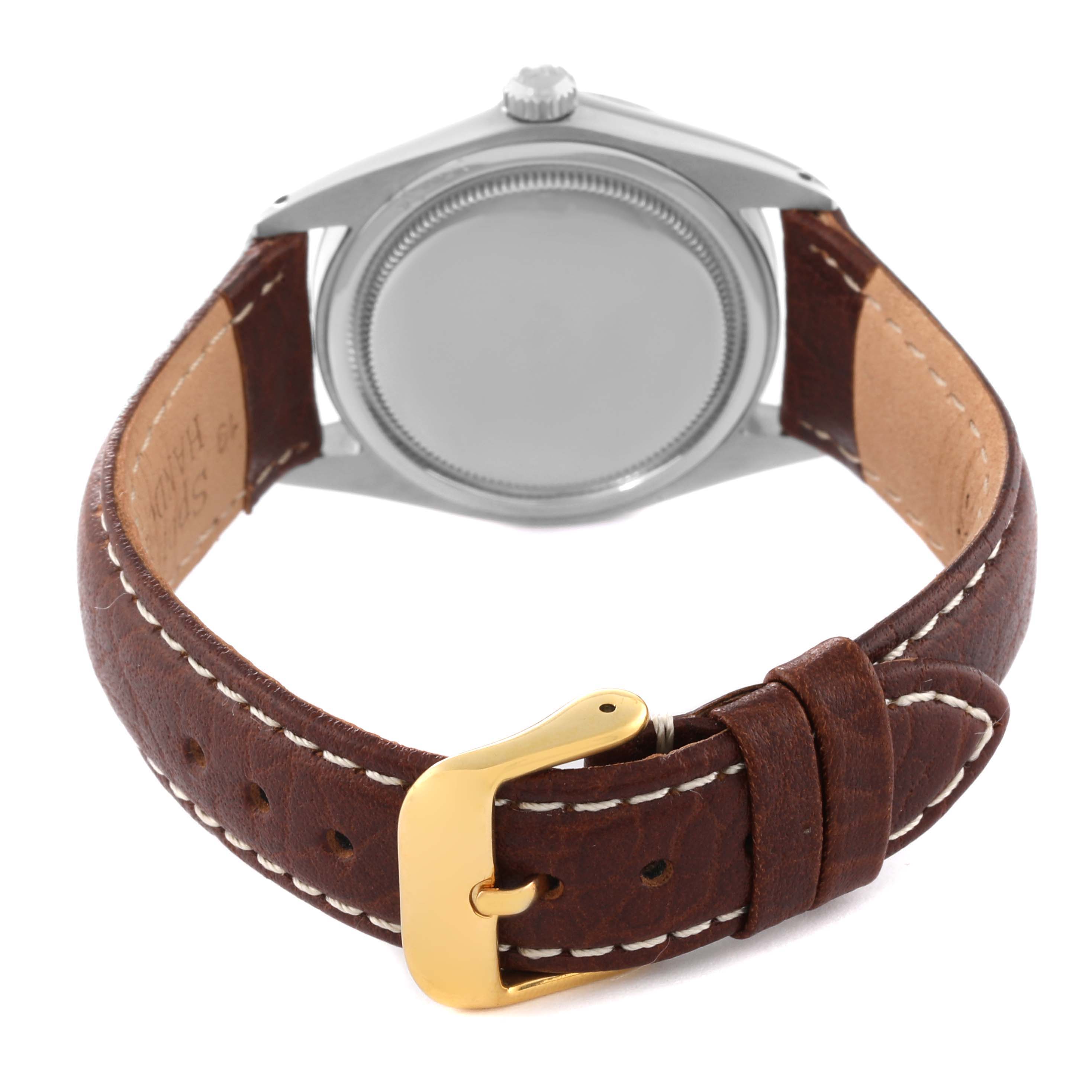 The image shows the back of a Rolex Vintage Collection 6694 Men's Stainless Steel Blue Dial 6694 Men's Stainless Steel Blue Dial watch with a brown leather strap and gold buckle.