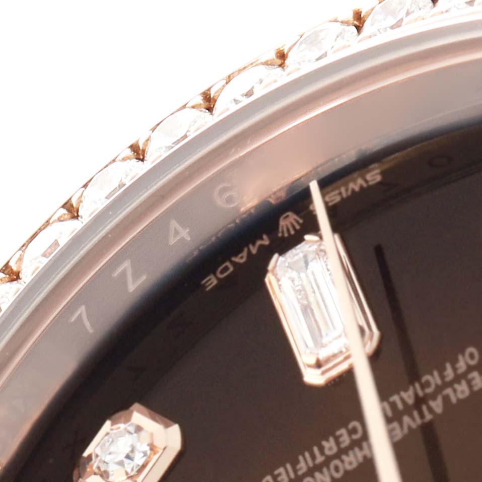 The image shows a close-up of a Rolex President 128345 Men
s Rose Gold Brown Dial watch face, highlighting the diamond-encrusted bezel and hour markers.