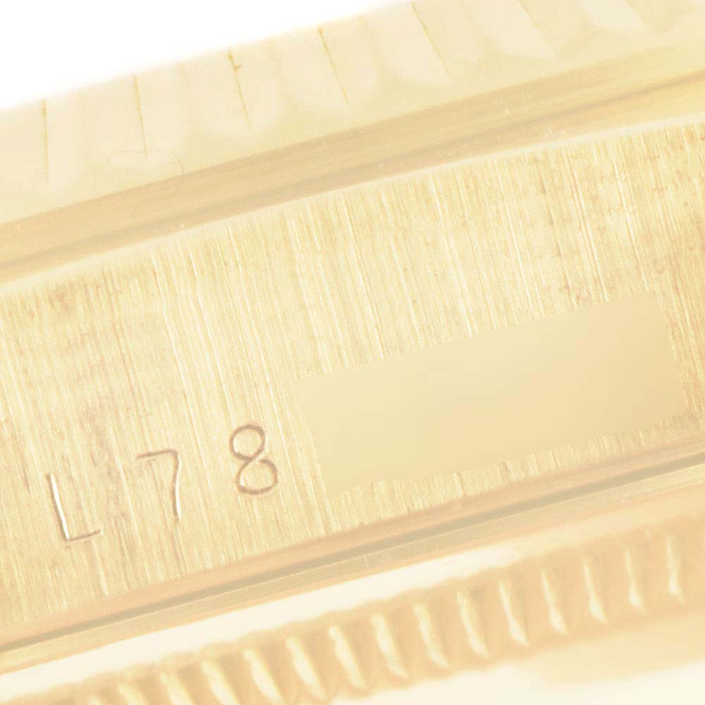 The image shows a close-up of the brushed side and fluted bezel of a Rolex President 18238 Men
s Yellow Gold Champagne Dial watch.