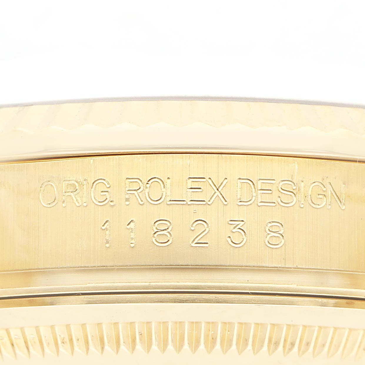 The image shows the side profile of a Rolex President 118238 Men
s Yellow Gold White Dial model, highlighting its engraved case with the model number 118238.