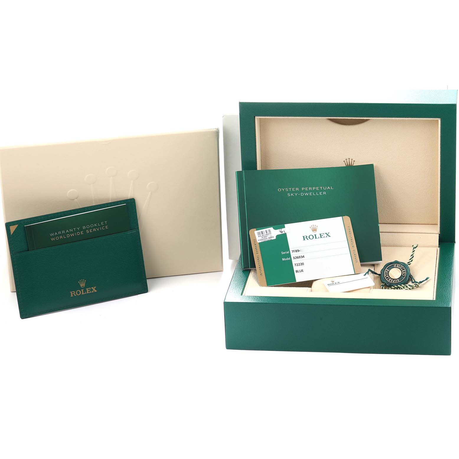 The image shows accessories for the Rolex Sky-Dweller 326934 Men
s Stainless Steel Blue Dial, including a box, warranty card, booklets, and a tag.