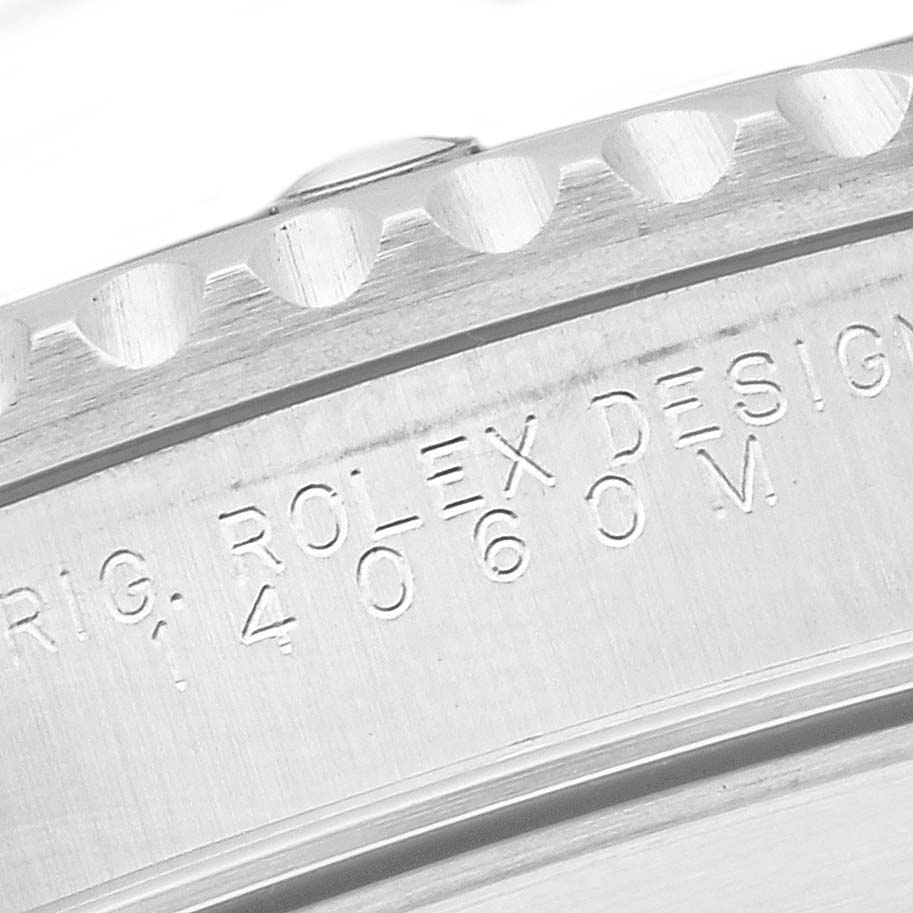 This close-up image shows the engraving on the casing of a Rolex Submariner 14060M Men
s Stainless Steel Black Dial 14060M Men
s Stainless Steel Black Dial watch.