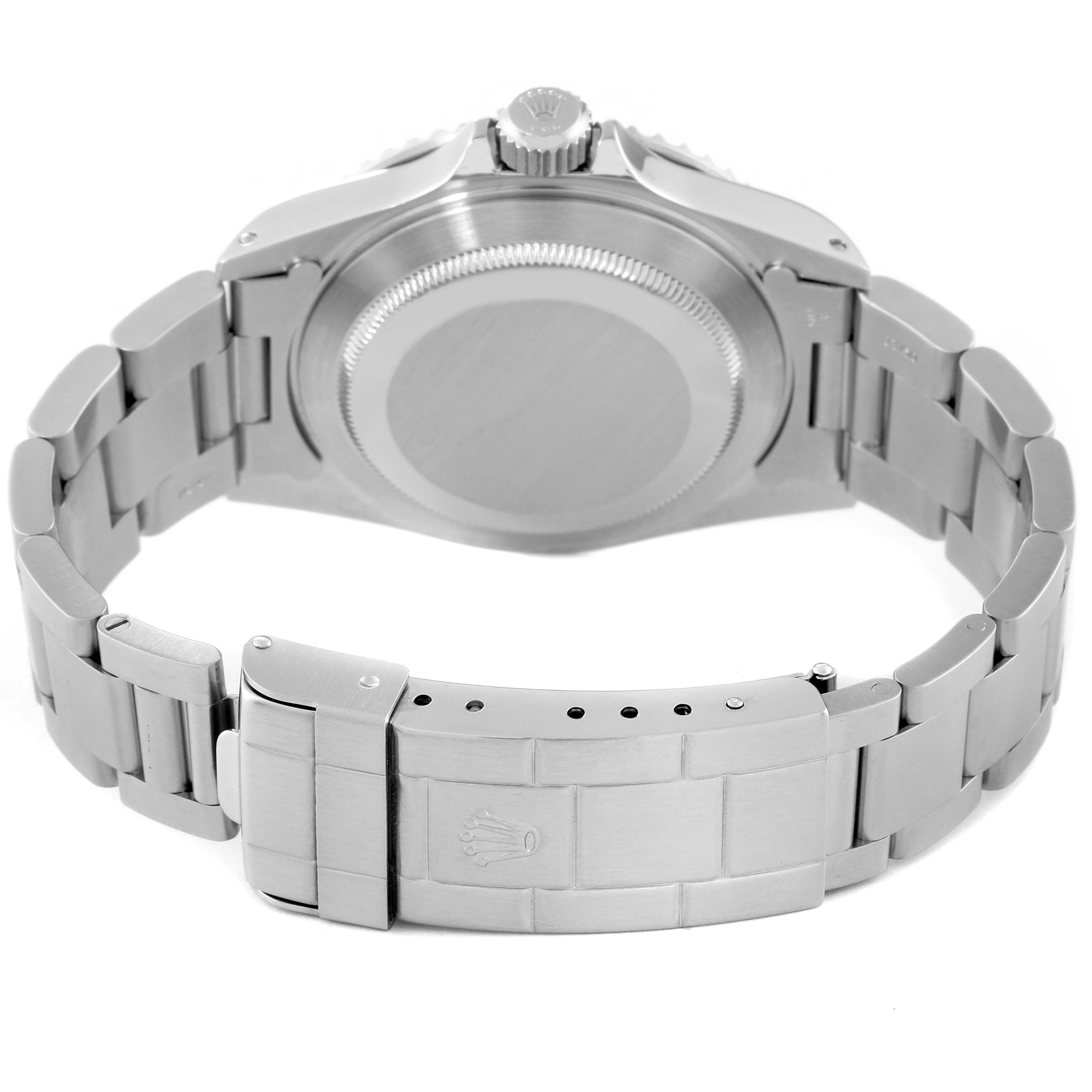 The image shows the back of a Rolex Submariner 14060M Men
s Stainless Steel Black Dial 14060M Men
s Stainless Steel Black Dial watch, featuring its case, crown, and Oyster bracelet with the clasp.