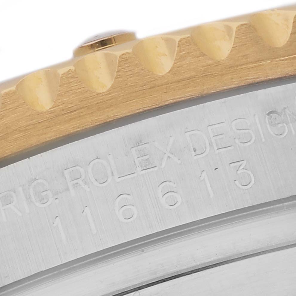This is a close-up angle of the Rolex Submariner 116613 Men's Steel and Gold (two tone) Blue Dial 116613 Men's Steel and Gold (two tone) Blue Dial watch showing the bezel and case with the model number engraved.