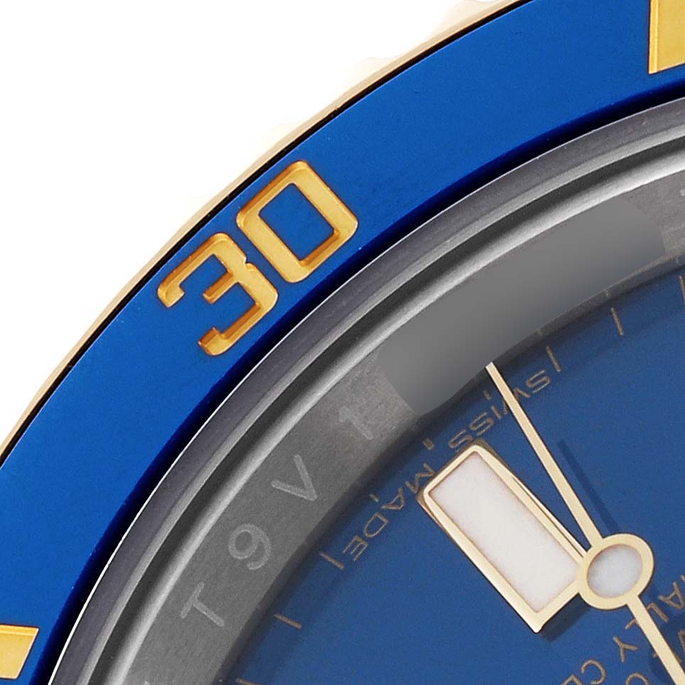 This close-up angle shows the bezel and part of the dial of the Rolex Submariner 116613 Men's Steel and Gold (two tone) Blue Dial 116613 Men's Steel and Gold (two tone) Blue Dial watch.