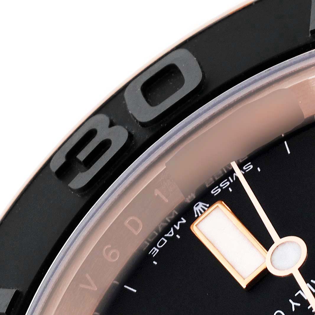 The image shows a close-up angle of the bezel and minute hand of the Rolex Yacht-Master 126655 Men's Rose Gold Black Dial 126655 Men's Rose Gold Black Dial watch.