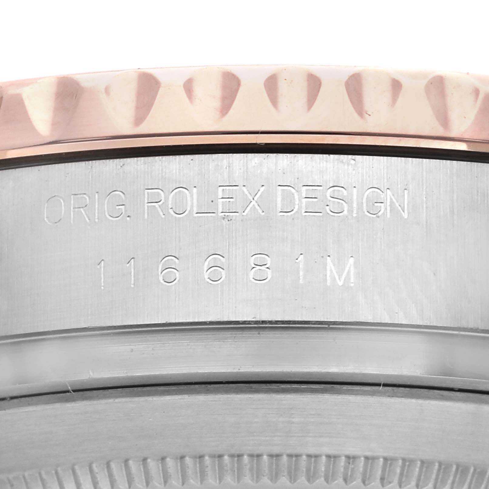 This image shows a close-up of the side of a Rolex Yacht-Master 116681 Men's Steel and Gold (two tone) White Dial 116681 Men's Steel and Gold (two tone) White Dial watch, revealing part of the bezel and engraved serial number.