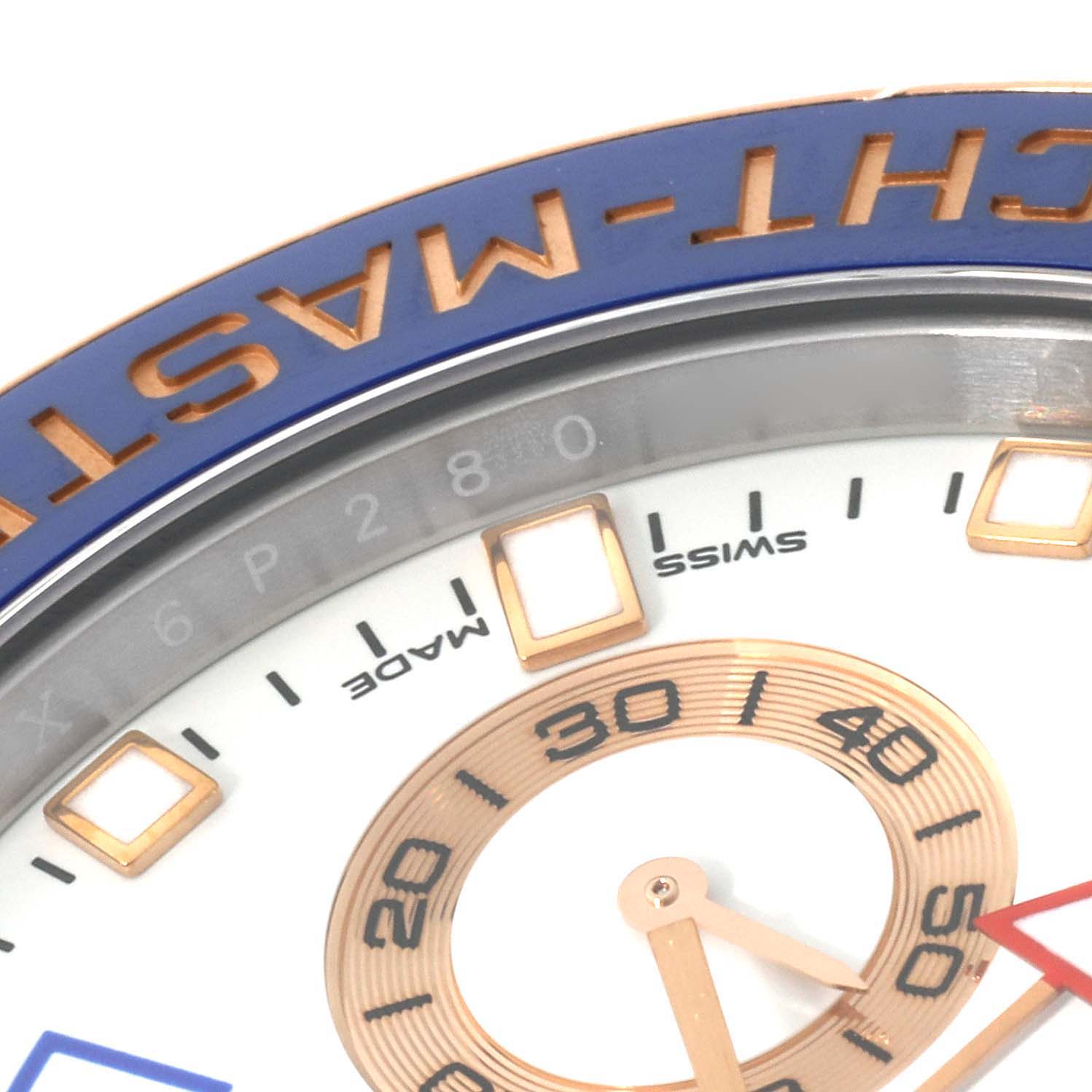 This close-up image shows the Yacht-Master model by Rolex, focusing on the bezel, part of the dial, and the minute hand.