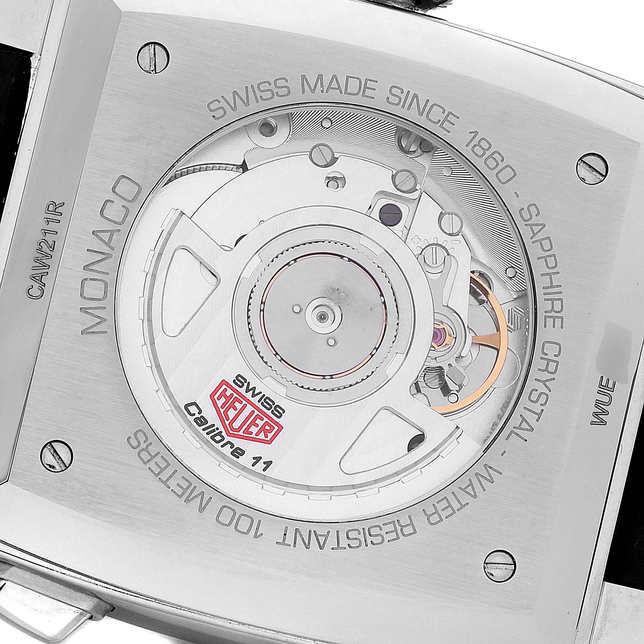 The image shows the back view of the Tag Heuer Monaco CAW211R.FC6401 Men's Stainless Steel Blue Dial CAW211R.FC6401 Men's Stainless Steel Blue Dial watch, highlighting its internal movement and inscriptions.