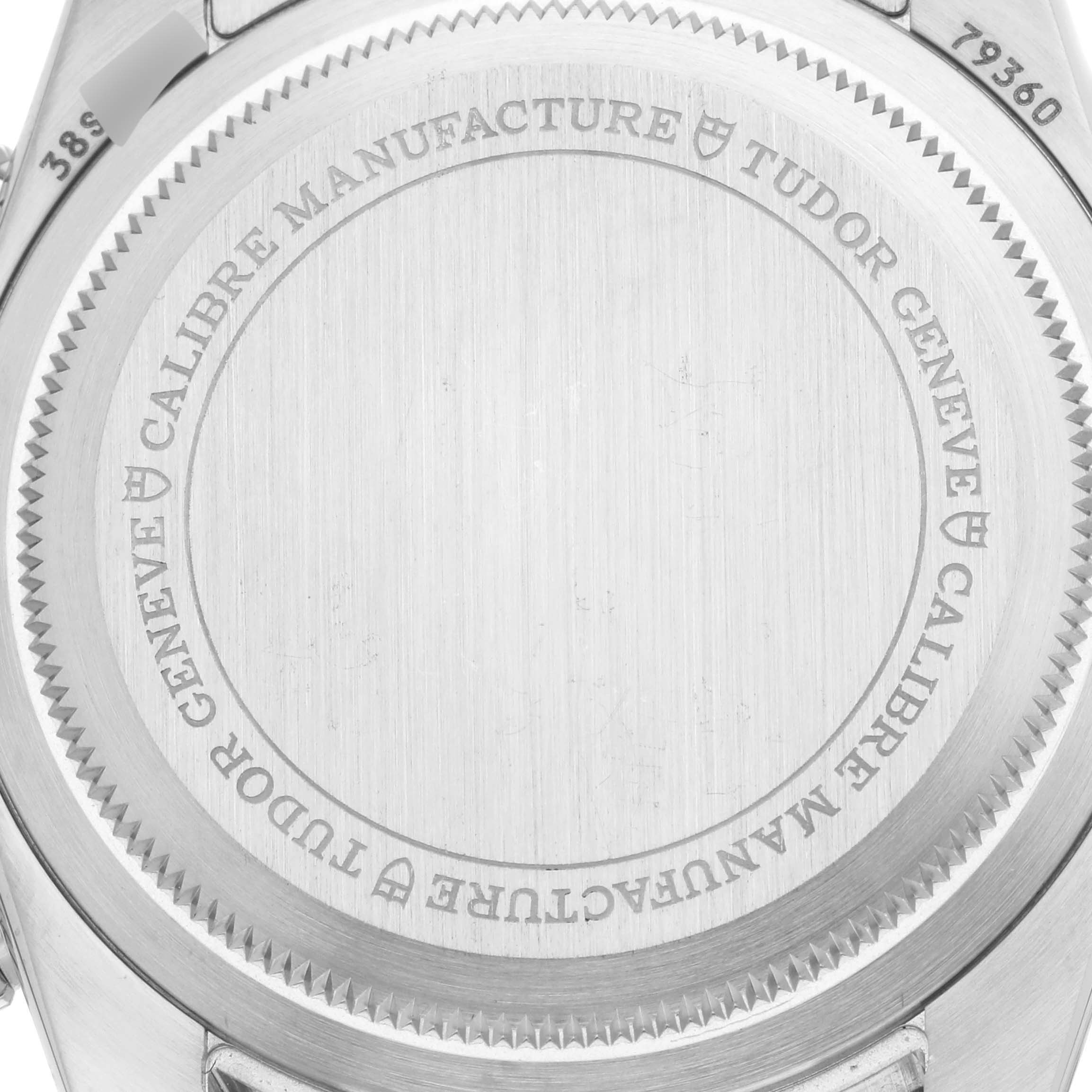 The image shows the back case of a Tudor Heritage Black Bay 79360N-002 Men's Stainless Steel White Dial 79360N-002 Men's Stainless Steel White Dial watch, featuring engravings and the serial number.