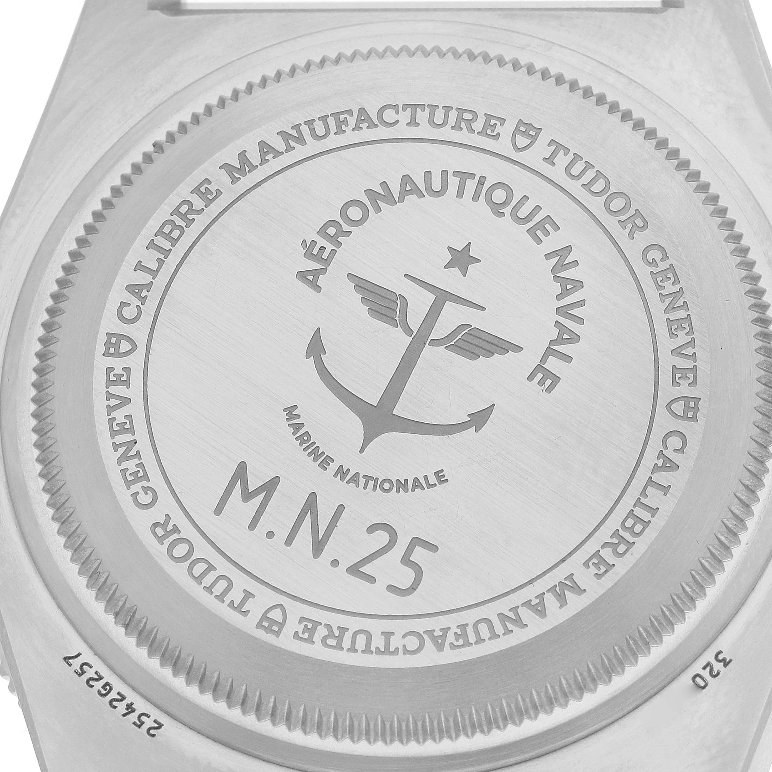 The image shows the case back of a Tudor Pelagos M2542G257NU Men
s Titanium Black Dial watch, featuring engravings and the Marine Nationale emblem.