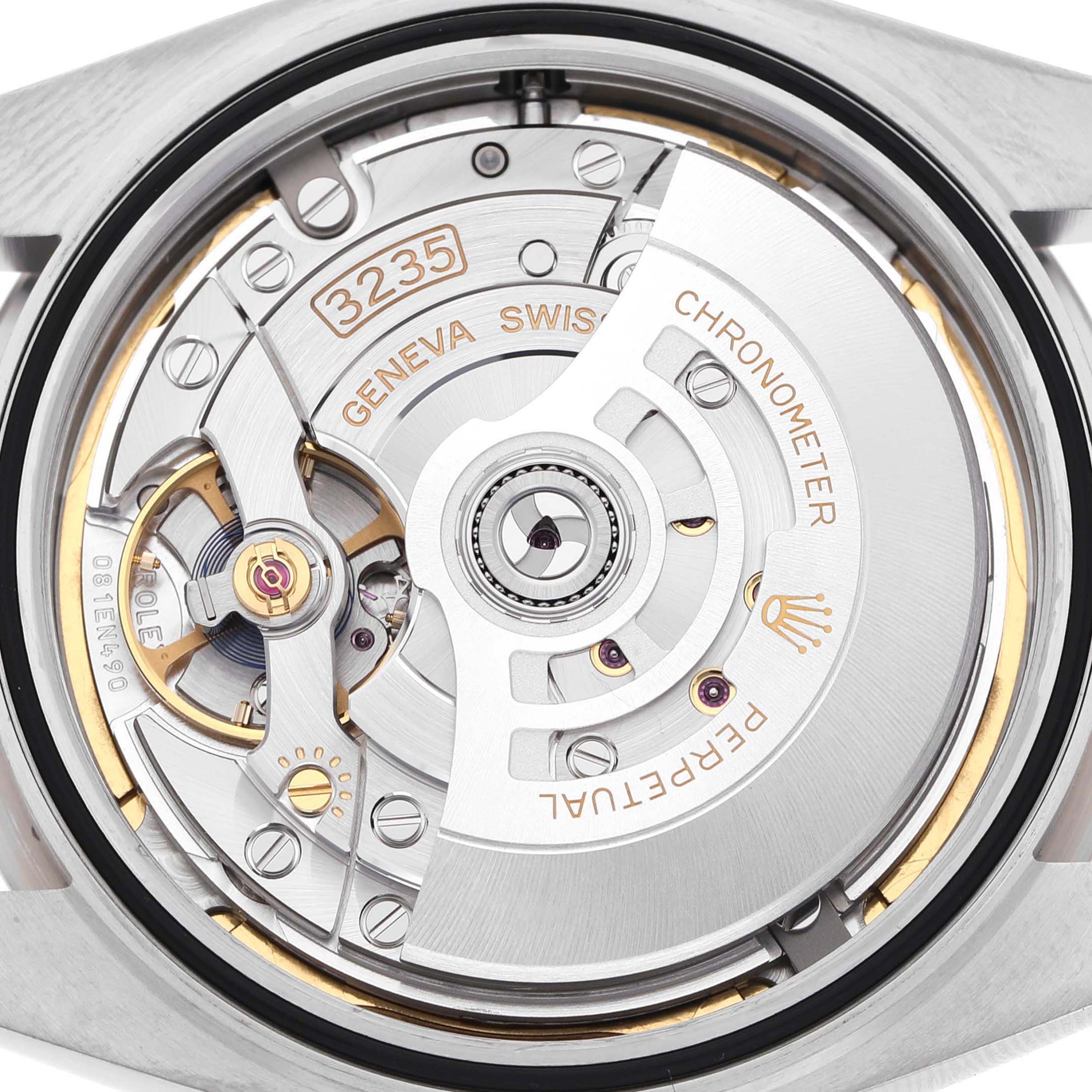 This image shows the movement of a watch, likely a different brand, from a rear view, with details of its mechanical components visible.