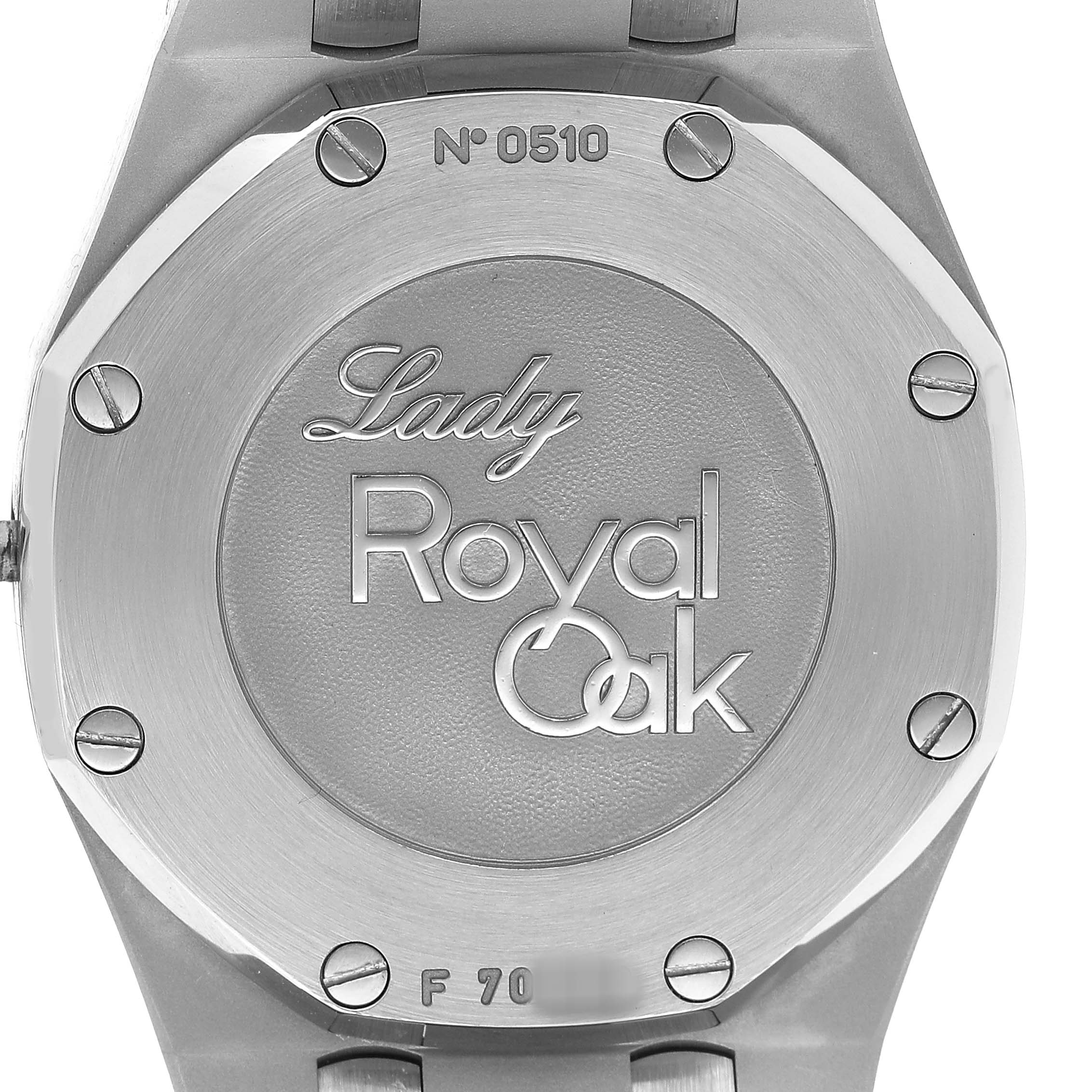 The image shows the case back of an Audemars Piguet Royal Oak 77321ST.ZZ.D002CR.01 Women's Stainless Steel Black Dial Lady watch, displaying engravings and serial number details.