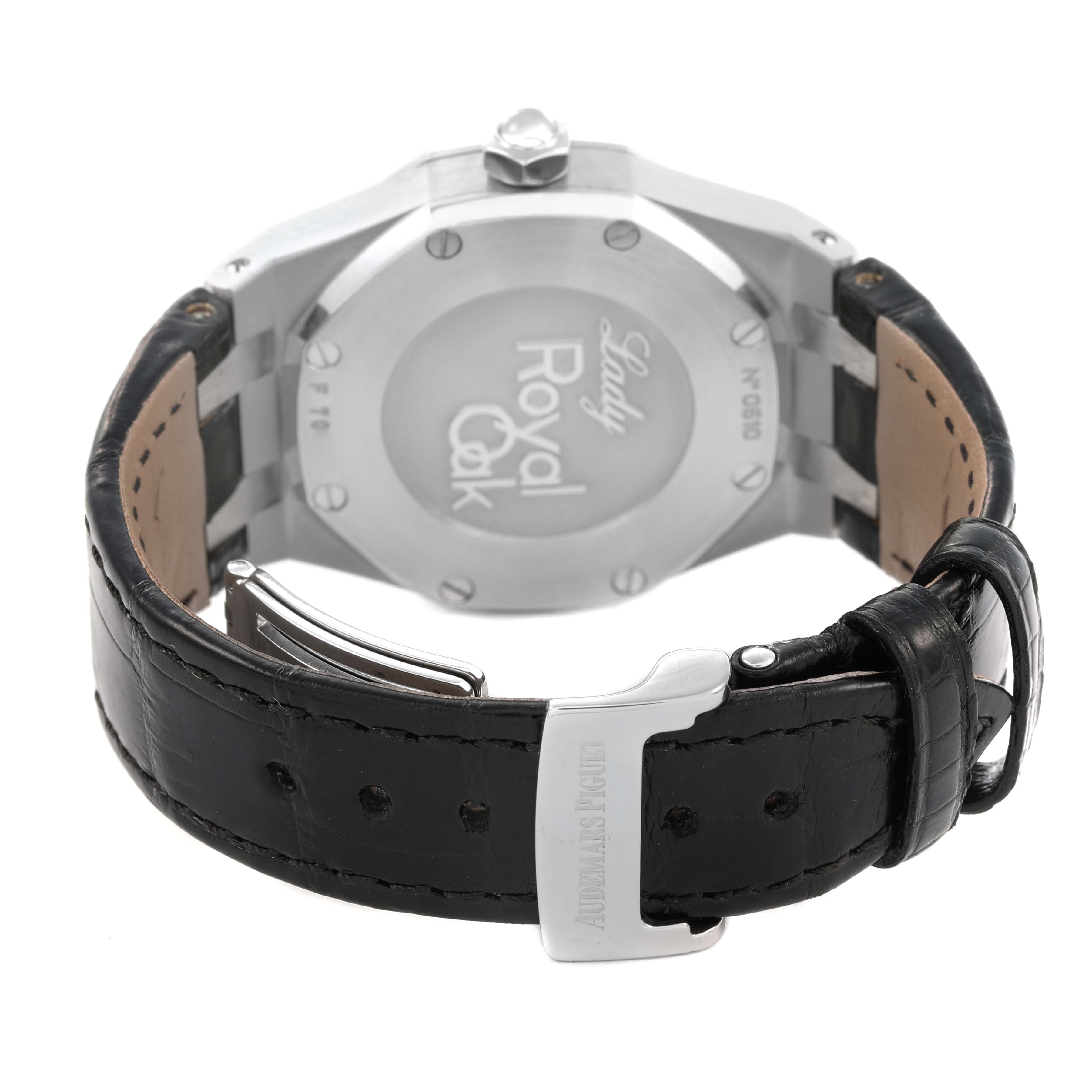 The image shows the back case and clasp of an Audemars Piguet Royal Oak 77321ST.ZZ.D002CR.01 Women's Stainless Steel Black Dial watch, highlighting the back engraving and leather strap.