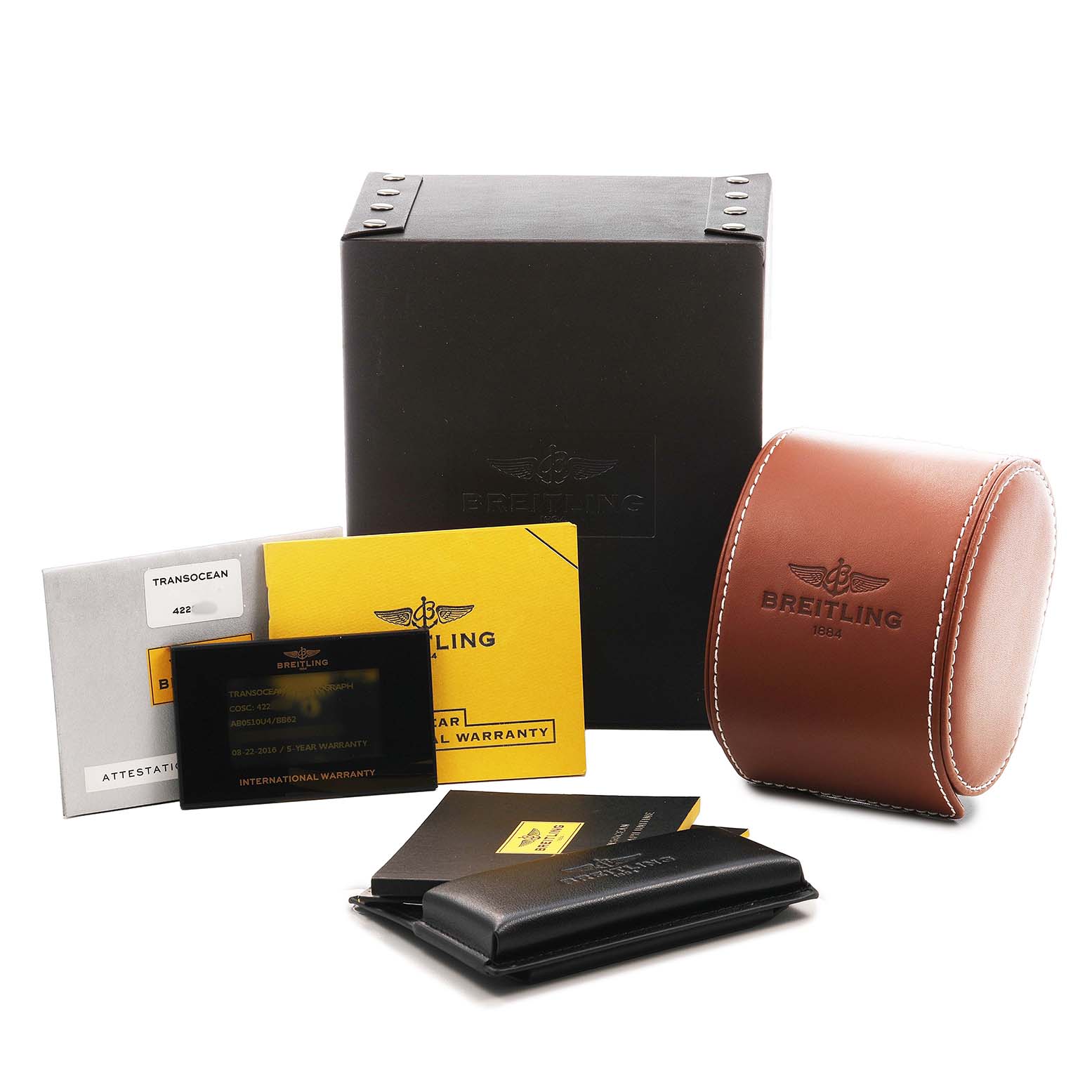 The image shows the packaging and accessories for the Breitling Transocean AB0510 Men's Stainless Steel Black Dial, including a black box, brown case, and warranty cards.