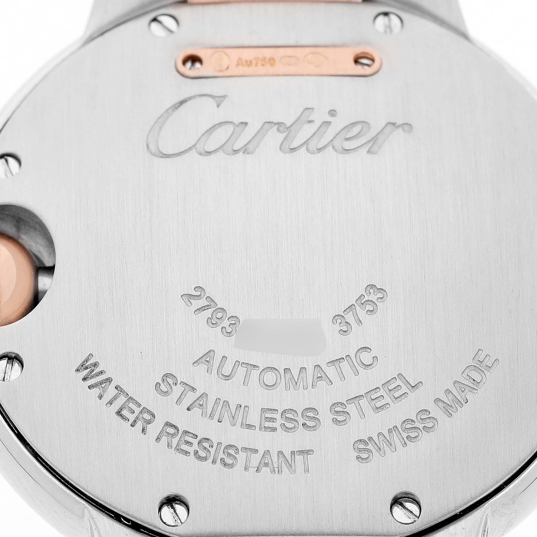 The image shows the stainless steel case back of a Cartier Ballon Bleu WE902077 Women's Steel and Gold (two tone) Silver Dial watch with engraved details like "AUTOMATIC" and "SWISS MADE."