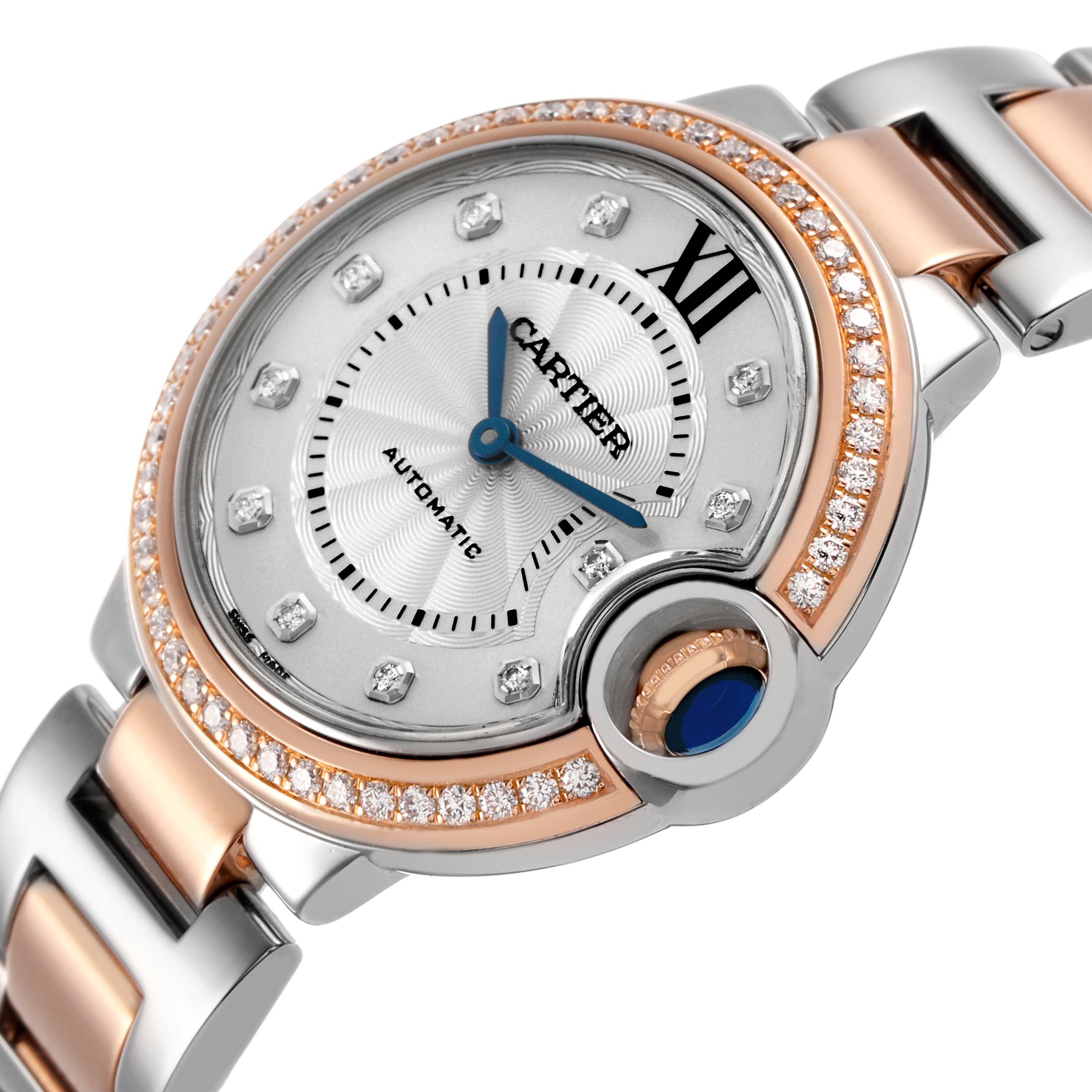 The image shows a close-up of the Cartier Ballon Bleu WE902077 Women's Steel and Gold (two tone) Silver Dial watch at an angle, highlighting the dial, bezel, crown, and part of the bracelet.