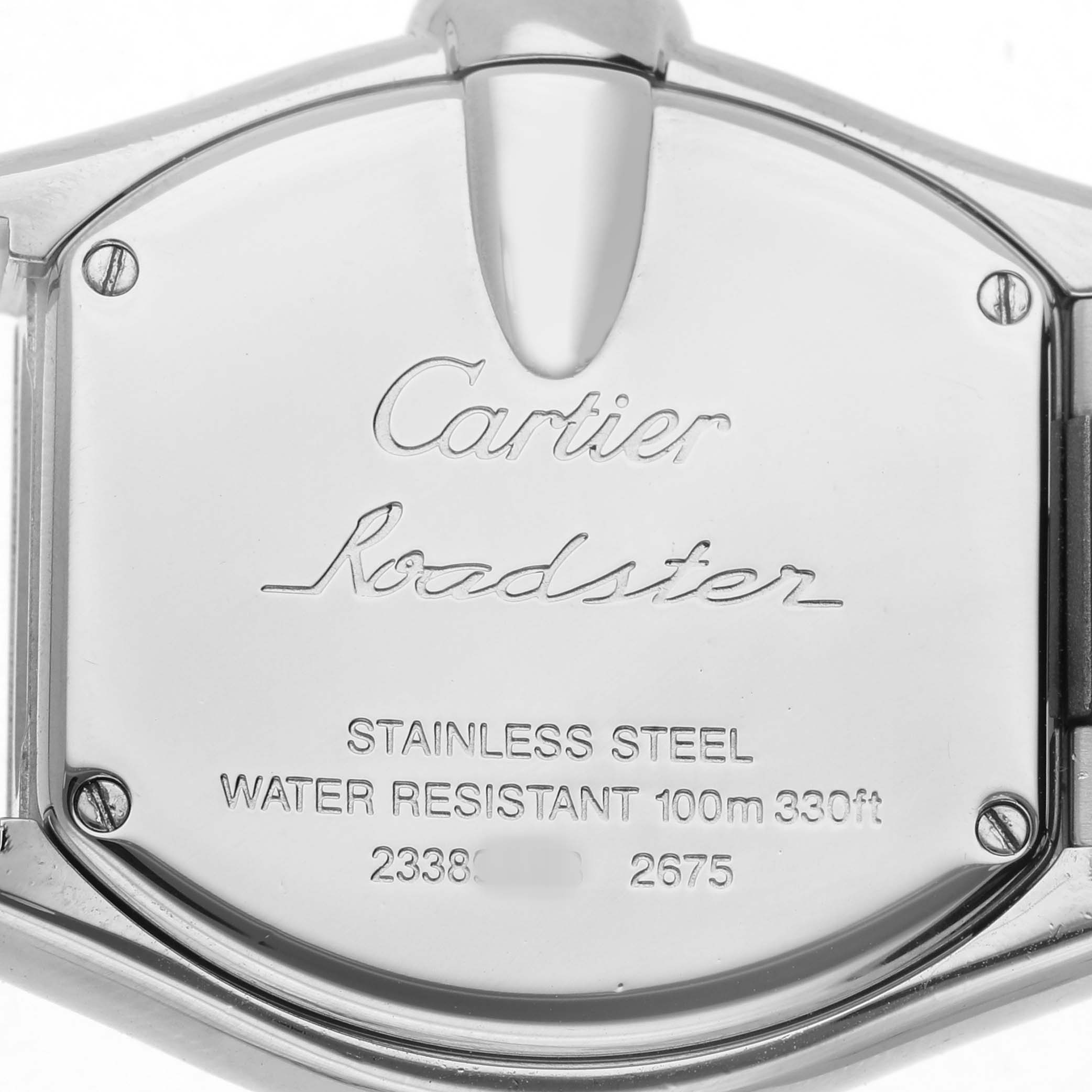 The image shows the back of a Cartier Roadster W62016V3 Women's Stainless Steel Silver Dial watch, highlighting its metal case and inscriptions.