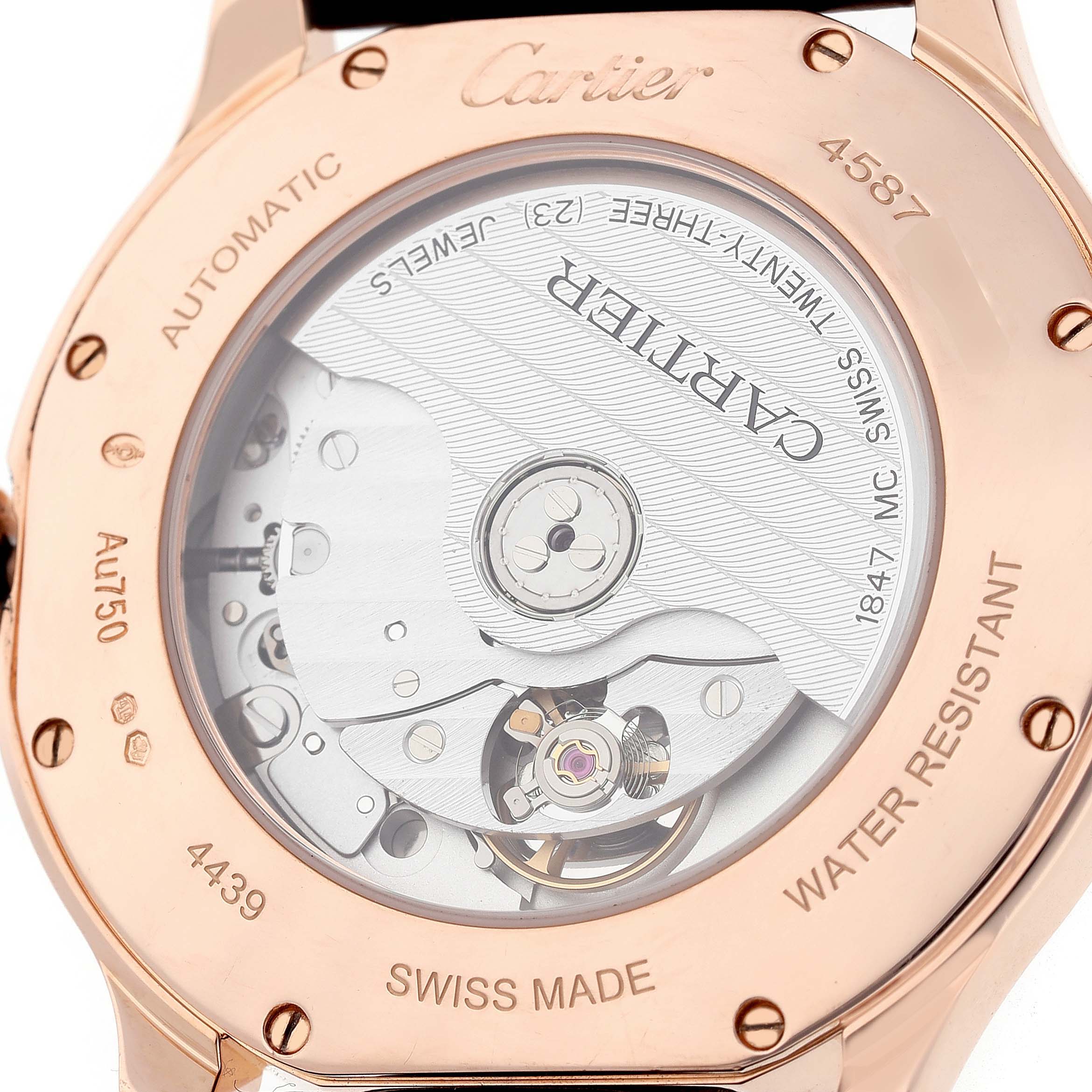 The image shows the back of a Cartier Ronde WGRN0011 Men's Rose Gold Silver Dial watch, highlighting its automatic movement and the inscriptions on the case back.