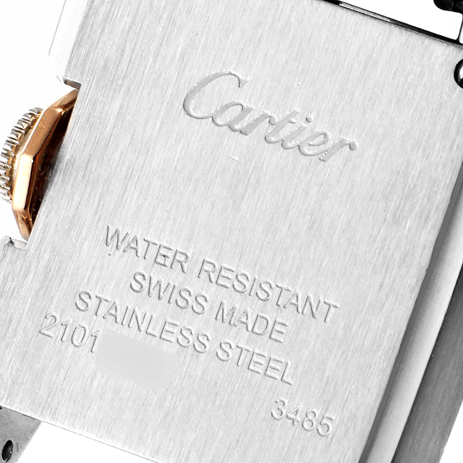 The image shows the back case of a Cartier Tank Anglaise W5310036 Women's Steel and Gold (two tone) Silver Dial W5310036 Women's Steel and Gold (two tone) Silver Dial watch, highlighting its inscriptions and part of the crown.
