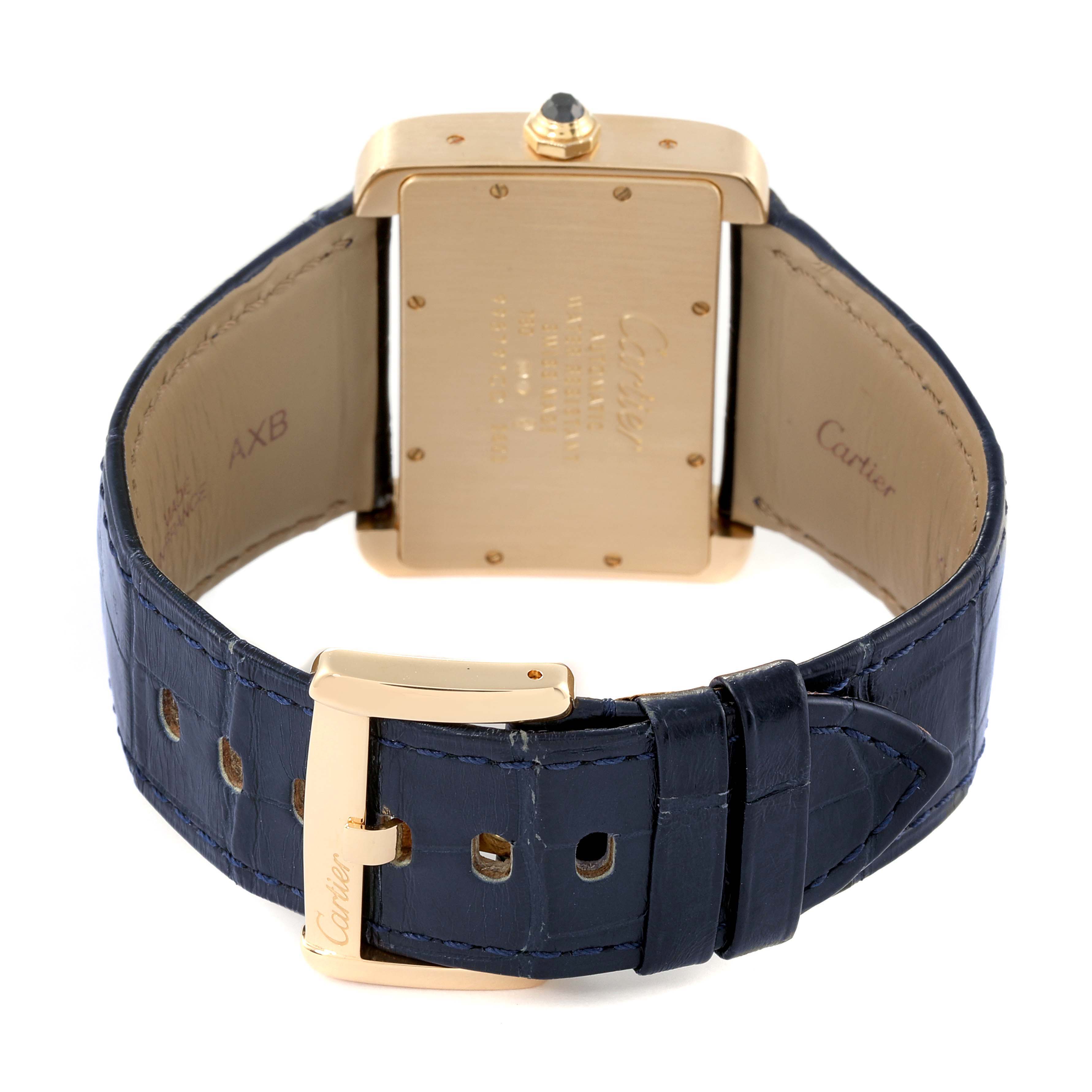 The Cartier Tank Divan W6300856‏ Women's Yellow Gold Silver Dial W6300856‏ Women's Yellow Gold Silver Dial watch is shown from the back, displaying its gold case and dark blue leather strap with a gold buckle.